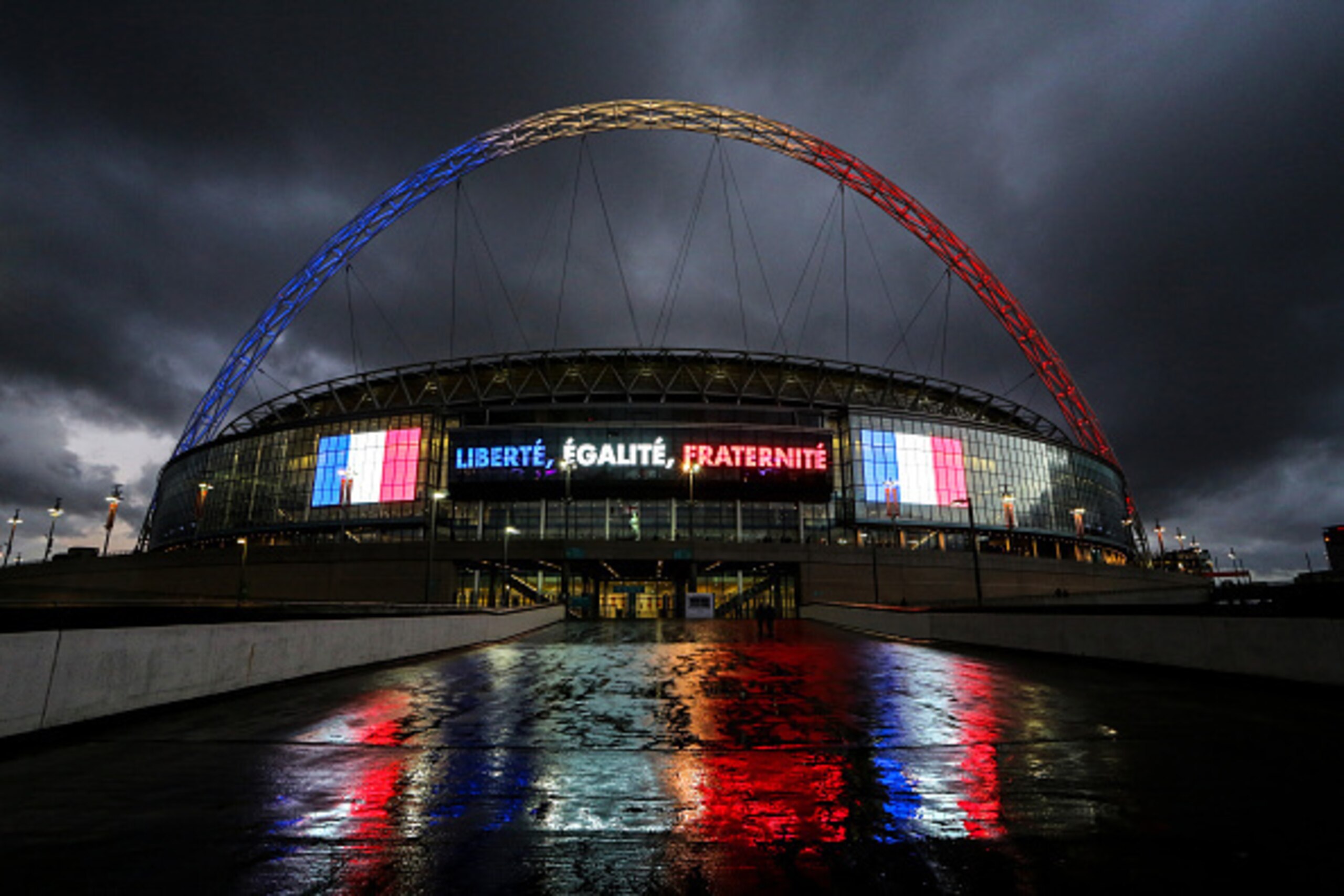 WEMBLEY, ENGLAND - NOVEMBER 17:  Wembley stadium with the arch lit up in red, white and blue  of the French tricolour flag before the international friendly between England and France at Wembley Stadium on November 17, 2015 in London, England.  (Photo by 