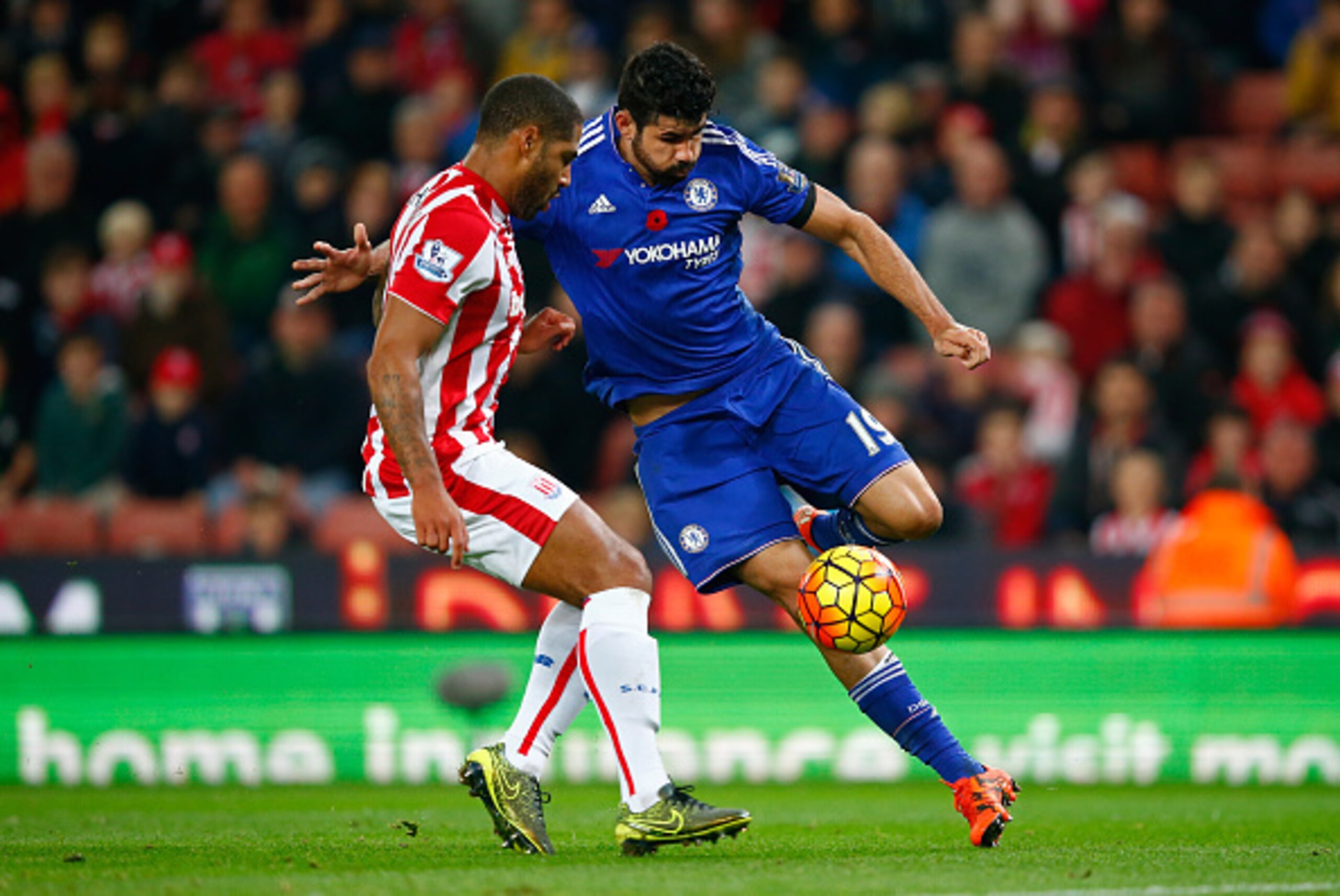 STOKE ON TRENT, ENGLAND - NOVEMBER 07:  Diego Costa of Chelsea and Glen Johnson of Stoke City compete for the ball during the Barclays Premier League match between Stoke City and Chelsea at Britannia Stadium on November 7, 2015 in Stoke on Trent, England.