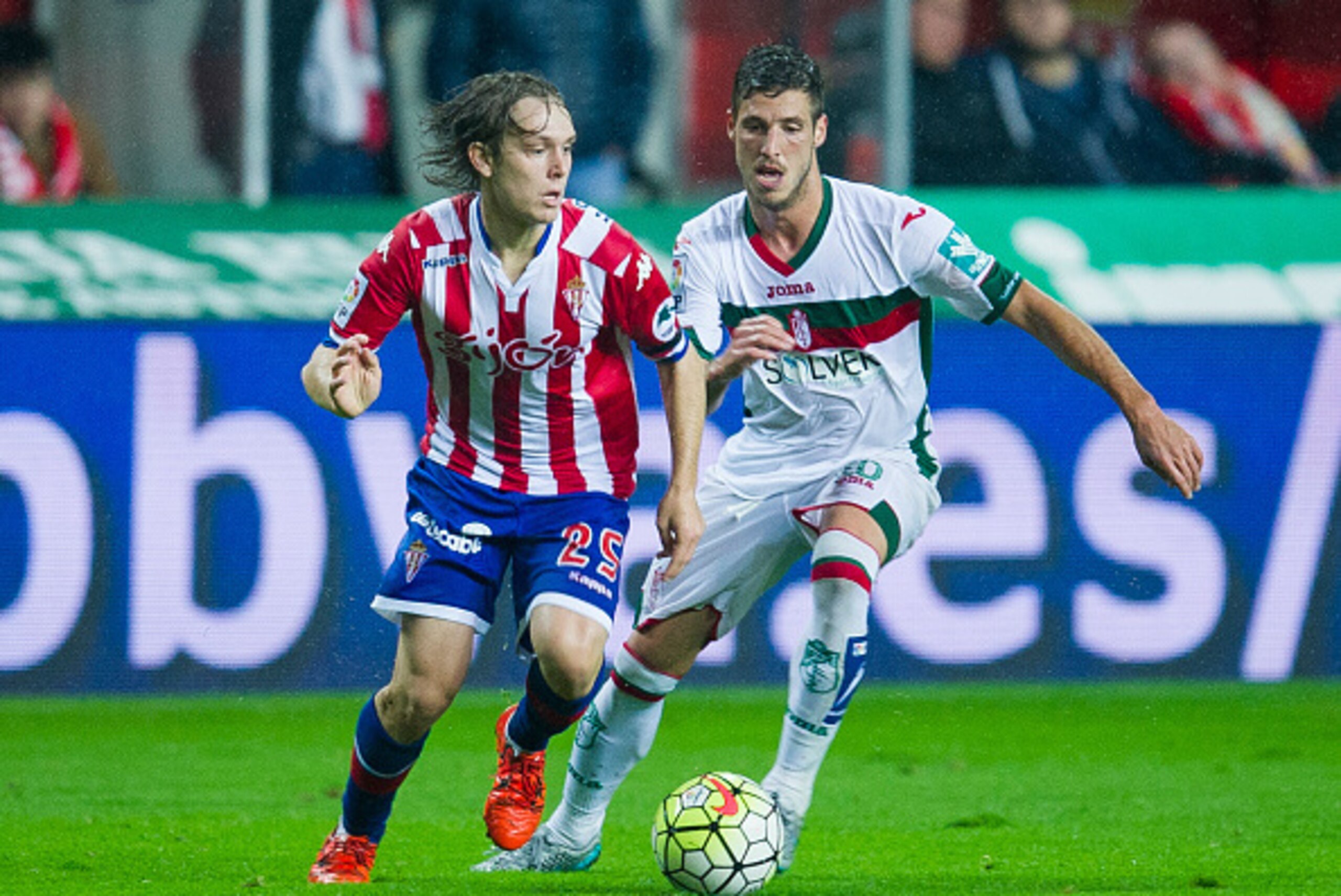 GIJON, SPAIN - OCTOBER 19:  Ruben Perez of Granada CF duels for the ball with Halilovic of Real Sporting de Gijon during the La Liga match between Real Sporting de Gijon and Granada CF at Estadio El Molinon on October 19, 2015 in Gijon, Spain.  (Photo by 