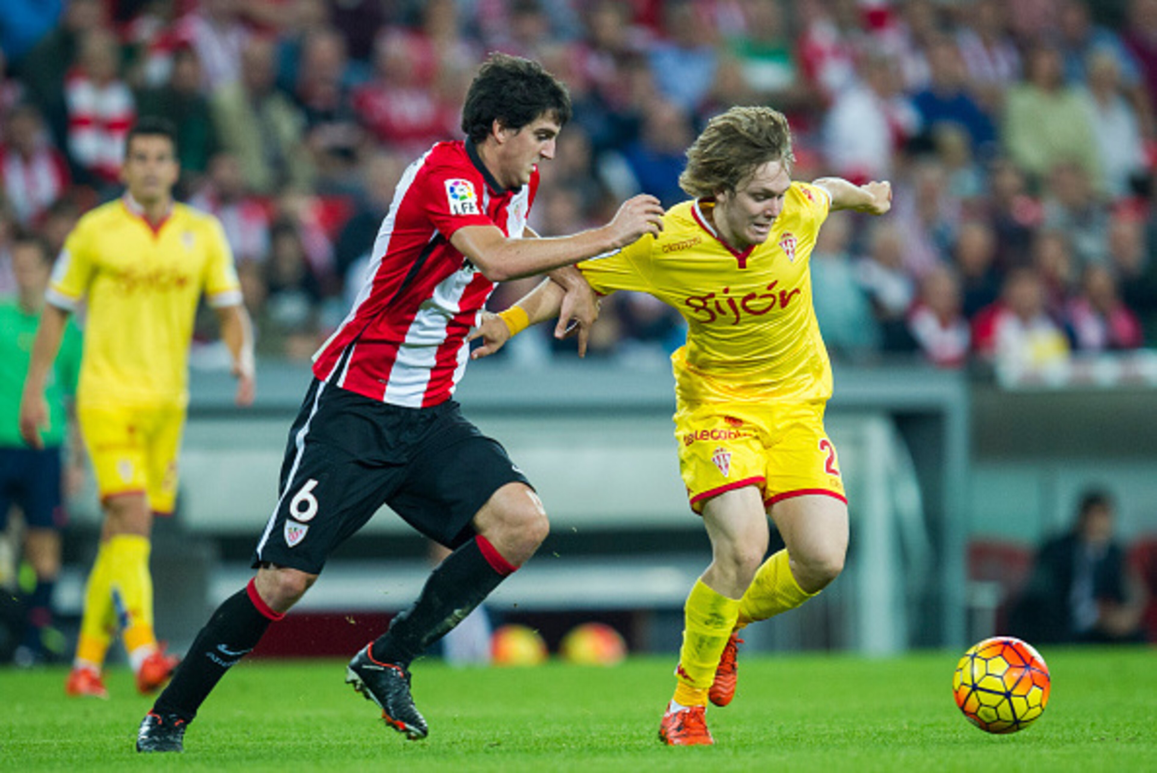 BILBAO, SPAIN - OCTOBER 26: Mikel San Jose of Athletic Club duels for the ball with Halilovic of Real Sporting de Gijon during the La Liga match between Athletic Club and Real Sporting de Gijon at San Mames Stadium on October 26, 2015 in Bilbao, Spain. BILBAO, SPAIN - OCTOBER 26: Mikel San Jose of Athletic Club duels for the ball with Halilovic of Real Sporting de Gijon during the La Liga match between Athletic Club and Real Sporting de Gijon at San Mames Stadium on October 26, 2015 in Bilbao, Spain.