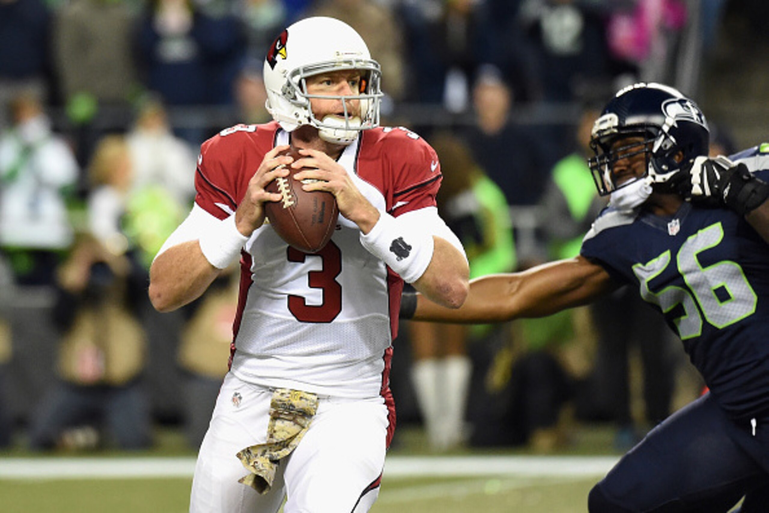 SEATTLE, WA - NOVEMBER 15:  Carson Palmer #3 of the Arizona Cardinals looks to pass as he is pressured by Cliff Avril #56 of the Seattle Seahawks during the first half of their game at CenturyLink Field on November 15, 2015 in Seattle, Washington.  (Photo
