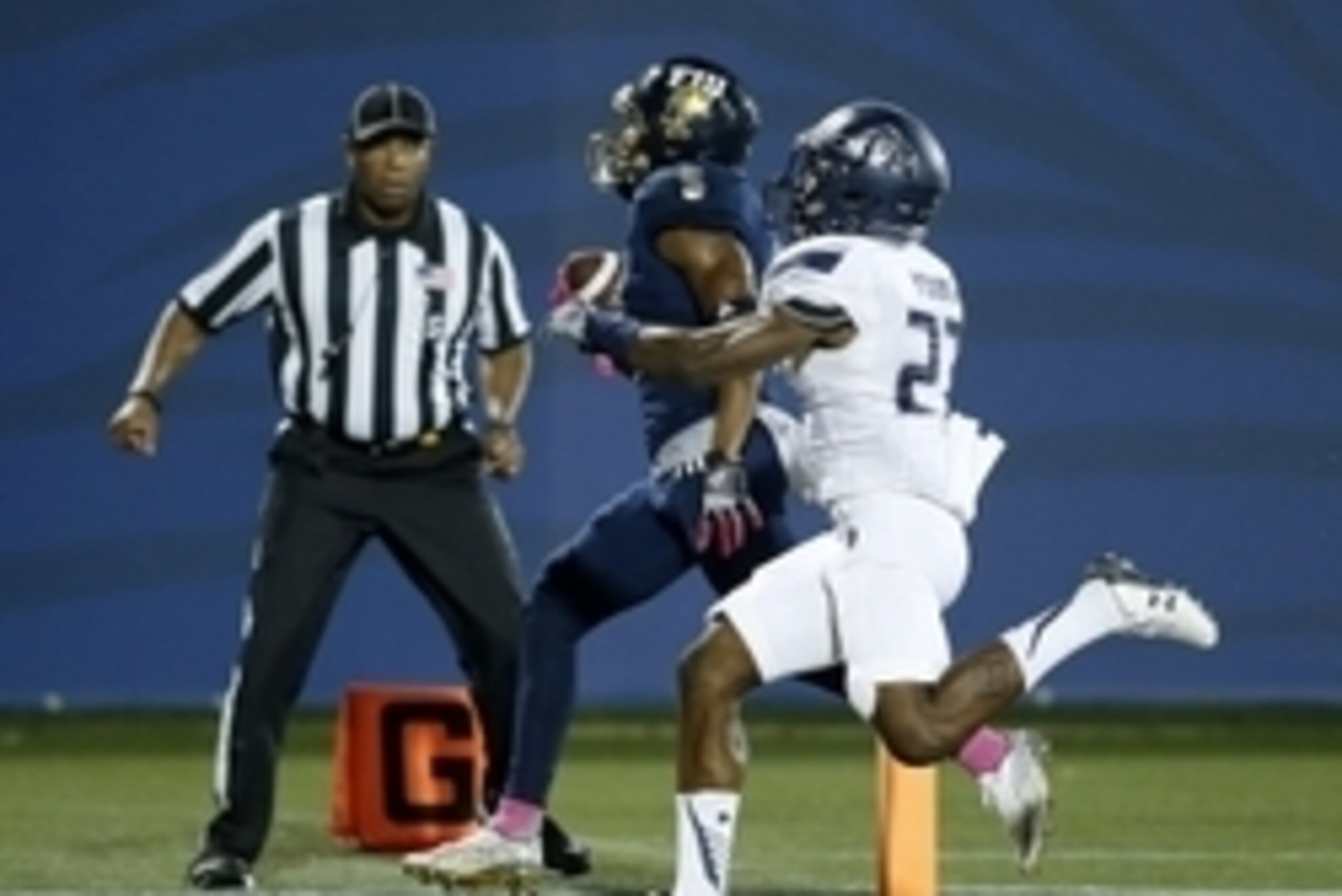 Oct 24, 2015; Miami, FL, USA;  FIU Golden Panthers wide receiver Clinton Taylor (5) catches a touchdown as Old Dominion Monarchs cornerback Aaron Young (27) pursues in the second half at FIU Stadium. The Golden Panthers won 41-12. Mandatory Credit: Robert