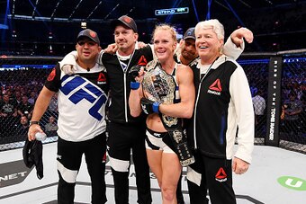 MELBOURNE, AUSTRALIA - NOVEMBER 15:  Holly Holm celebrates with Team Holm after her second round KO (head kick and punches) against Ronda Rousey (not pictured) to win their UFC women's bantamweight championship bout during the UFC 193 event at Etihad Stad