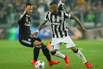 TURIN, ITALY - MAY 05:  Arturo Vidal (R) of Juventus FC competes for the ball with Jose (L) of Real Madrid CF during the UEFA Champions League semi final match between Juventus and Real Madrid CF at Juventus Arena on May 5, 2015 in Turin, Italy.  (Photo b