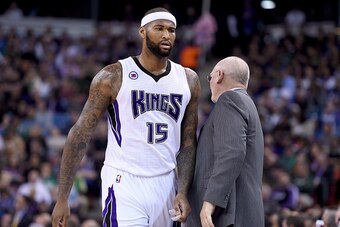 SACRAMENTO, CA - FEBRUARY 20:  DeMarcus Cousins #15 of the Sacramento Kings walks back to the bench past head coach George Karl after Cousins was called for a technical foul against the Boston Celtics in the first quarter at Sleep Train Arena on February 