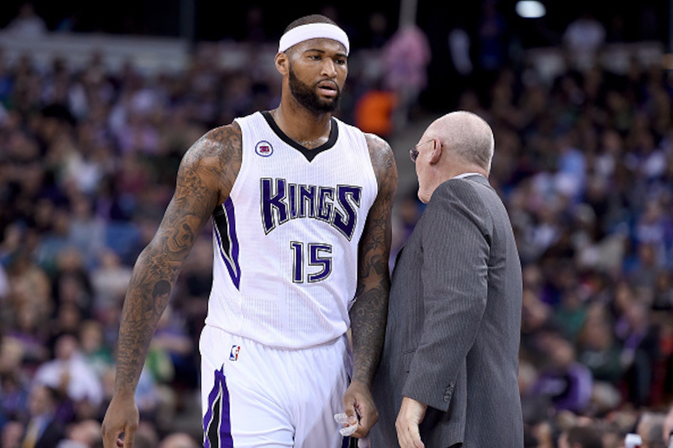 SACRAMENTO, CA - FEBRUARY 20:  DeMarcus Cousins #15 of the Sacramento Kings walks back to the bench past head coach George Karl after Cousins was called for a technical foul against the Boston Celtics in the first quarter at Sleep Train Arena on February 