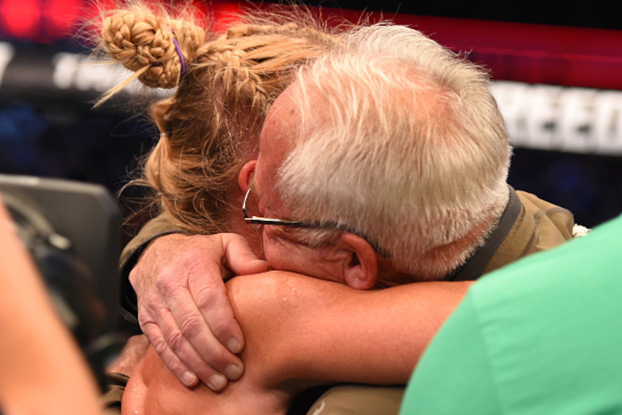 MELBOURNE, AUSTRALIA - NOVEMBER 15:  Holly Holm celebrates her second round KO (head kick and punches) over Ronda Rousey (not pictured) with her father Roger Holm (R) after her UFC women's bantamweight championship bout during the UFC 193 event at Etihad 