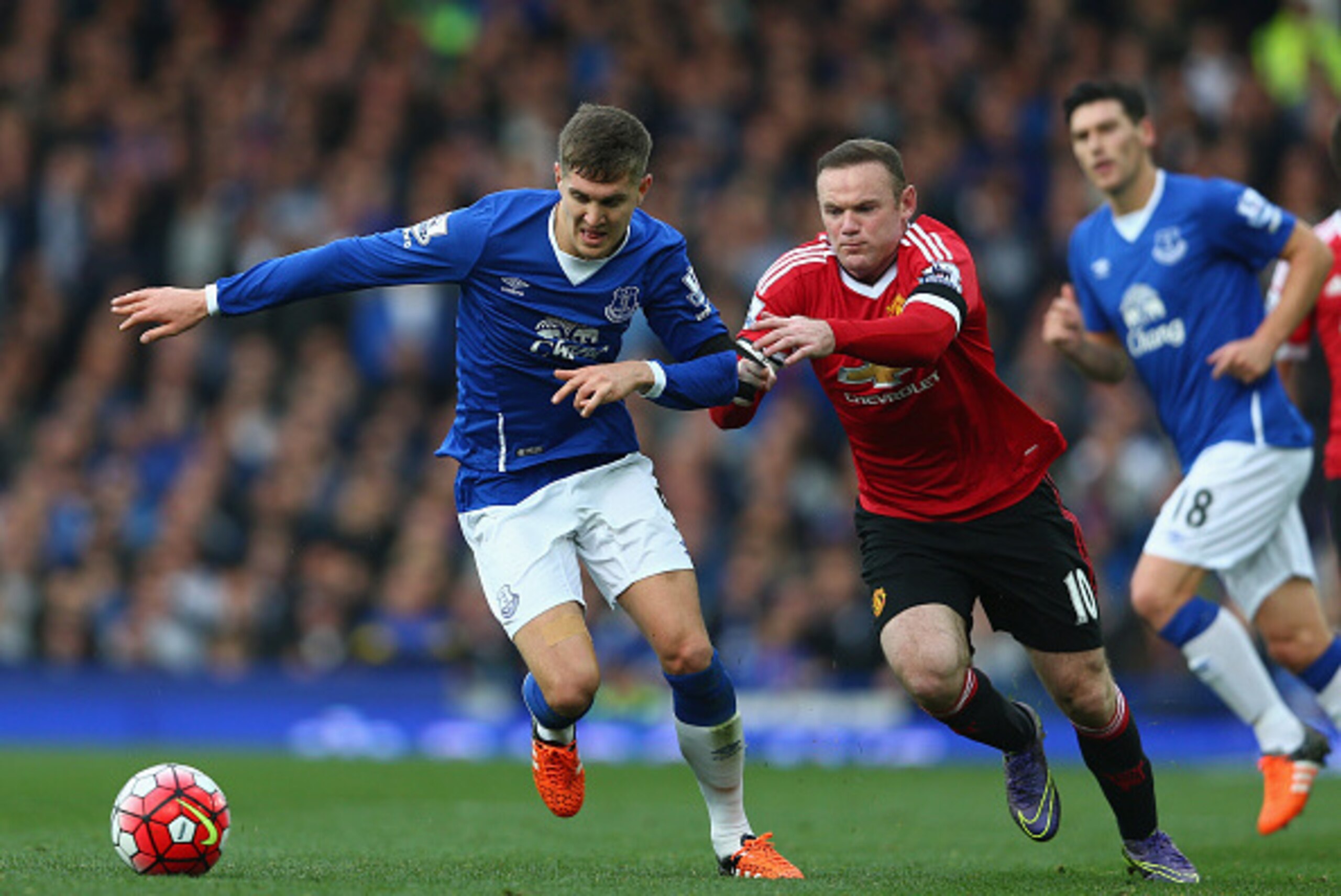 LIVERPOOL, ENGLAND - OCTOBER 17: Wayne Rooney of Manchester United and John Stones of Everton compete for the ball during the Barclays Premier League match between Everton and Manchester United at Goodison Park on October 17, 2015 in Liverpool, England.  