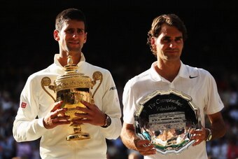 LONDON, ENGLAND - JULY 06:  Novak Djokovic of Serbia poses with the Gentlemen's Singles Trophy next to Roger Federer of Switzerland following his victory in the Gentlemen's Singles Final match on day thirteen of the Wimbledon Lawn Tennis Championships at 