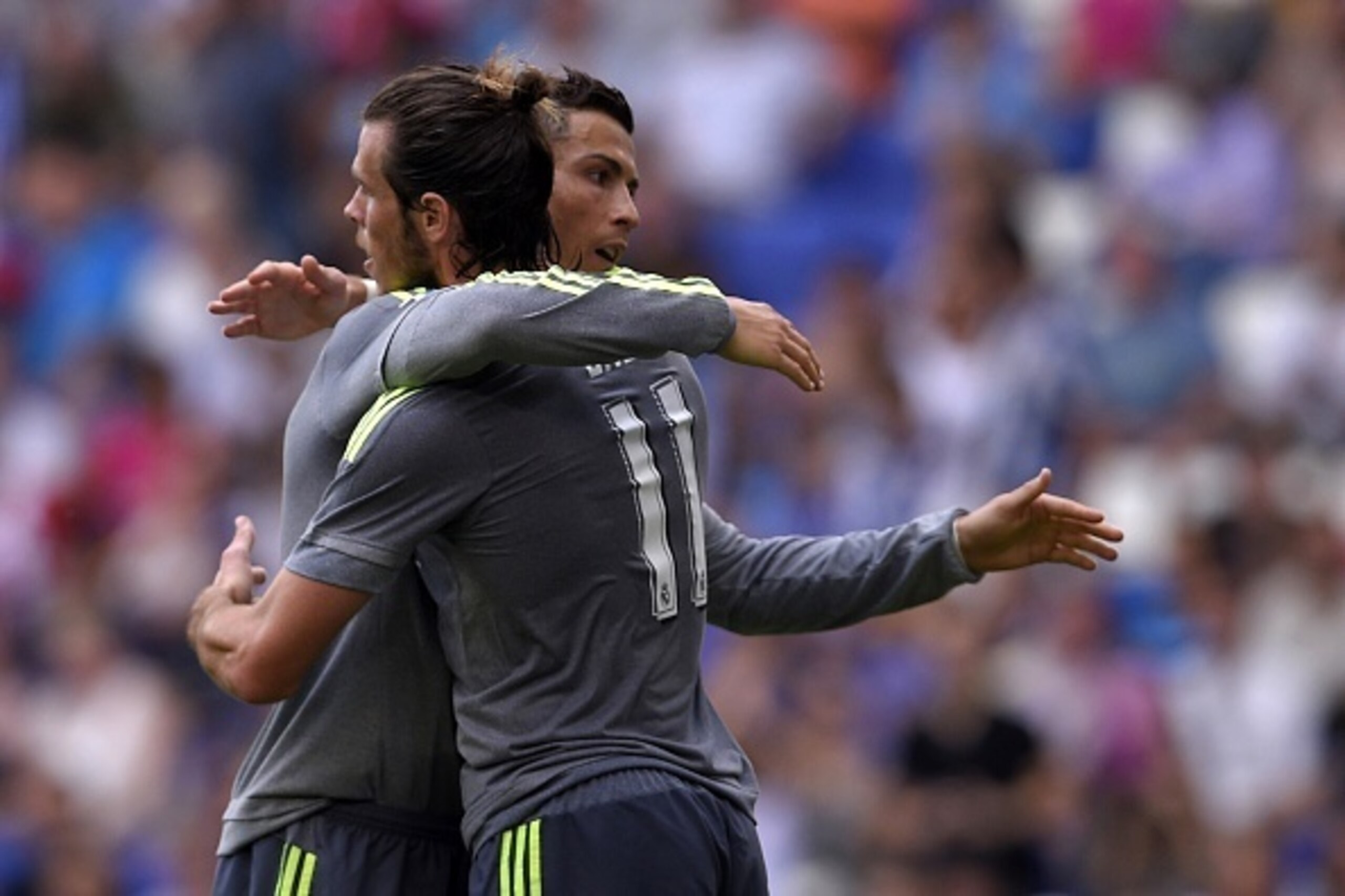 Real Madrid's Portuguese forward Cristiano Ronaldo (L) is congratulated by Real Madrid's Welsh forward Gareth Bale after scoring a goal during the Spanish league football match RCD Espanyol vs Real Madrid CF at the Power8 stadium in Cornella de Llobregat 