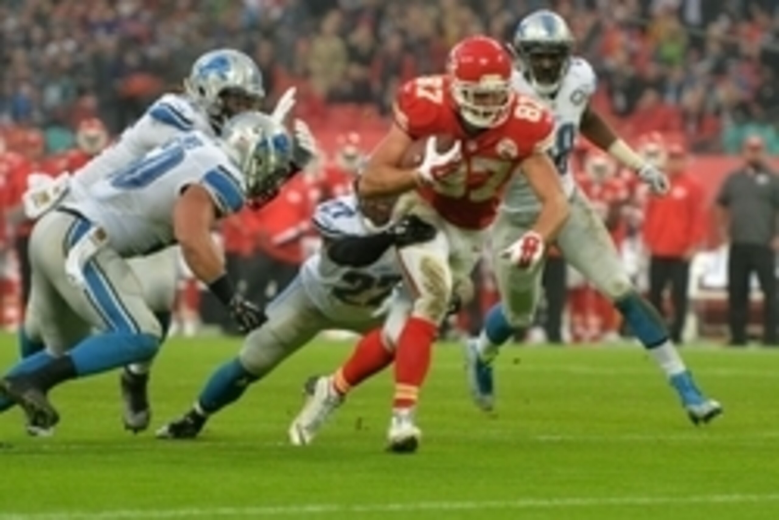 Nov 1, 2015; London, United Kingdom; Kansas City Chiefs tight end Travis Kelce (87) is defended by Detroit Lions safety Glover Quin (57) and linebacker Travis Lewis (50) on a 2-yard touchdown reception during game 14 of the NFL International Series at Wem