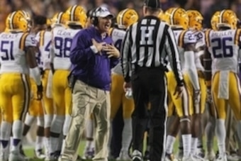 Nov 14, 2015; Baton Rouge, LA, USA; LSU Tigers head coach Les Miles (L) argues with a referee during the first quarter at Tiger Stadium. The Razorbacks won 31-14. Mandatory Credit: Crystal LoGiudice-USA TODAY Sports