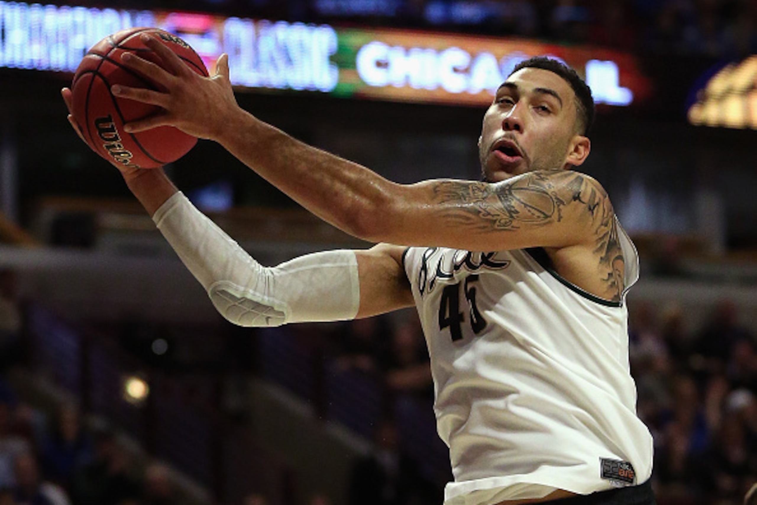 CHICAGO, IL - NOVEMBER 17:  Denzel Valentine #45 of the Michigan State Spartans rebounds against the Kansas Jayhawks during the Champions Classic at the United Center on November 17, 2015 in Chicago, Illinois. Michigan State defeated Kansas 79-73.  (Photo