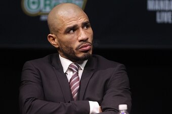 Former WBC Middleweight World Champion Miguel Cotto , from Puerto Rico looks on as two time world champion, Saul 'Canelo' Alvarez from Guadalajara, Mexico speaks during a press conference in Las Vegas, Nevada on November 18, 2015.  Cotto was stripped of h