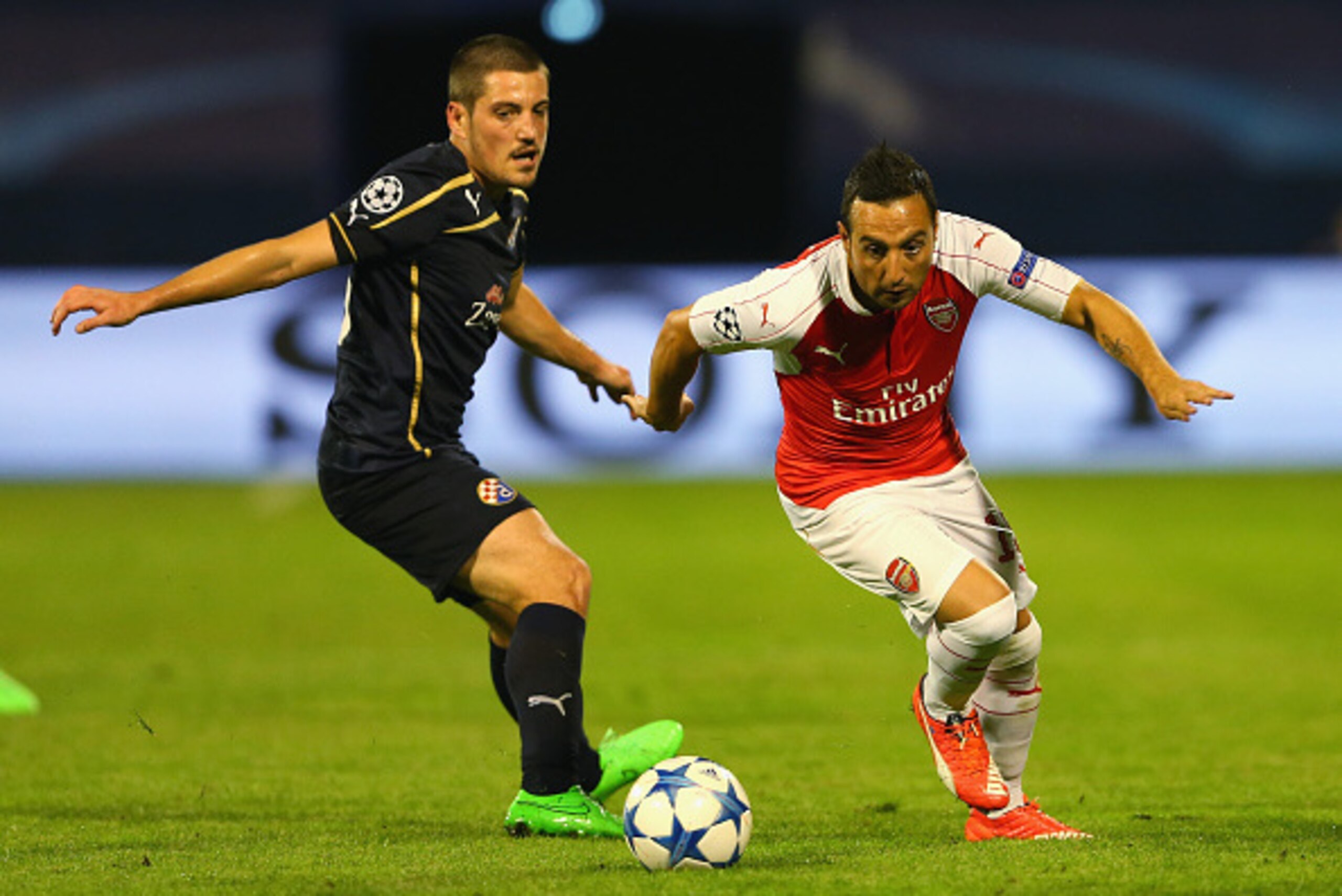 ZAGREB, CROATIA - SEPTEMBER 16:  Santi Cazorla of Arsenal goes past Arijan Ademi of Dinamo Zagreb during the UEFA Champions League Group F match between Dinamo Zagreb and Arsenal at Maksimir Stadium on September 16, 2015 in Zagreb, Croatia.  (Photo by Ale