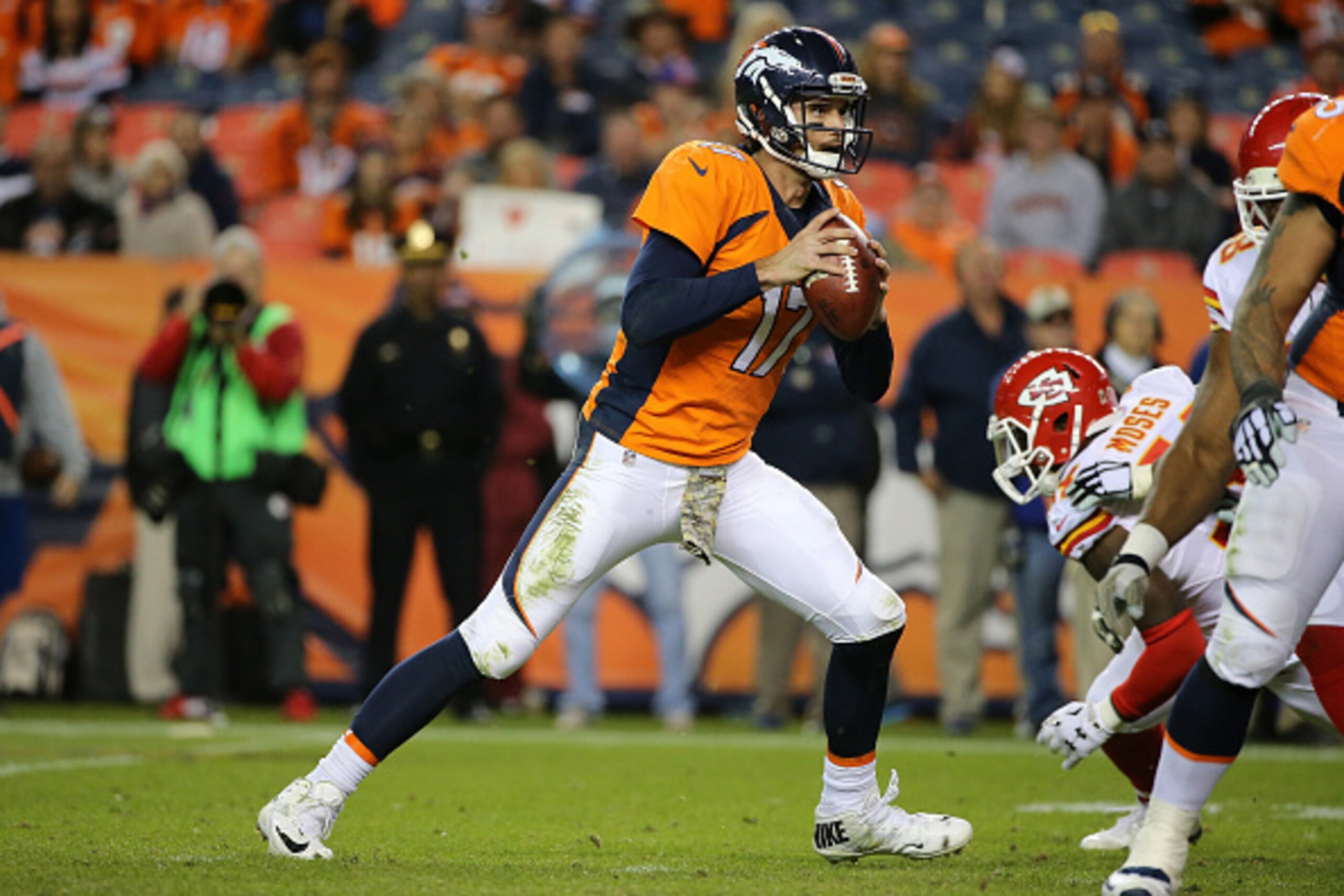 DENVER, CO - NOVEMBER 15:  Quarterback Brock Osweiler #17 of the Denver Broncos looks for a receiver against the Kansas City Chiefs at Sports Authority Field at Mile High on November 15, 2015 in Denver, Colorado. The Chiefs defeated the Broncos 29-13.  (P