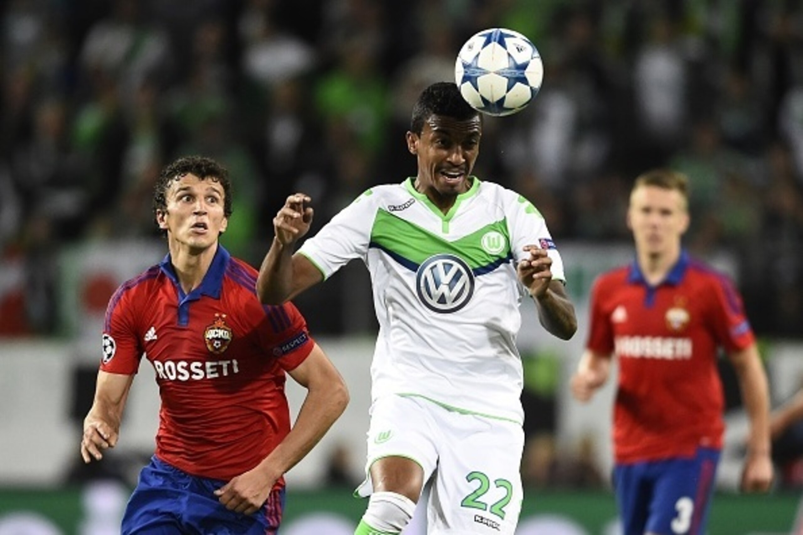 Wolfsburg's Brazilian midfielder Luiz Gustavo (C), CSKA Moscow's Finnish midfielder Roman Eremenko (L) and CSKA Moscow's Swedish midfielder Pontus Wernbloom vie for the ball during the UEFA Champions League group B first leg football match between VfL Wol