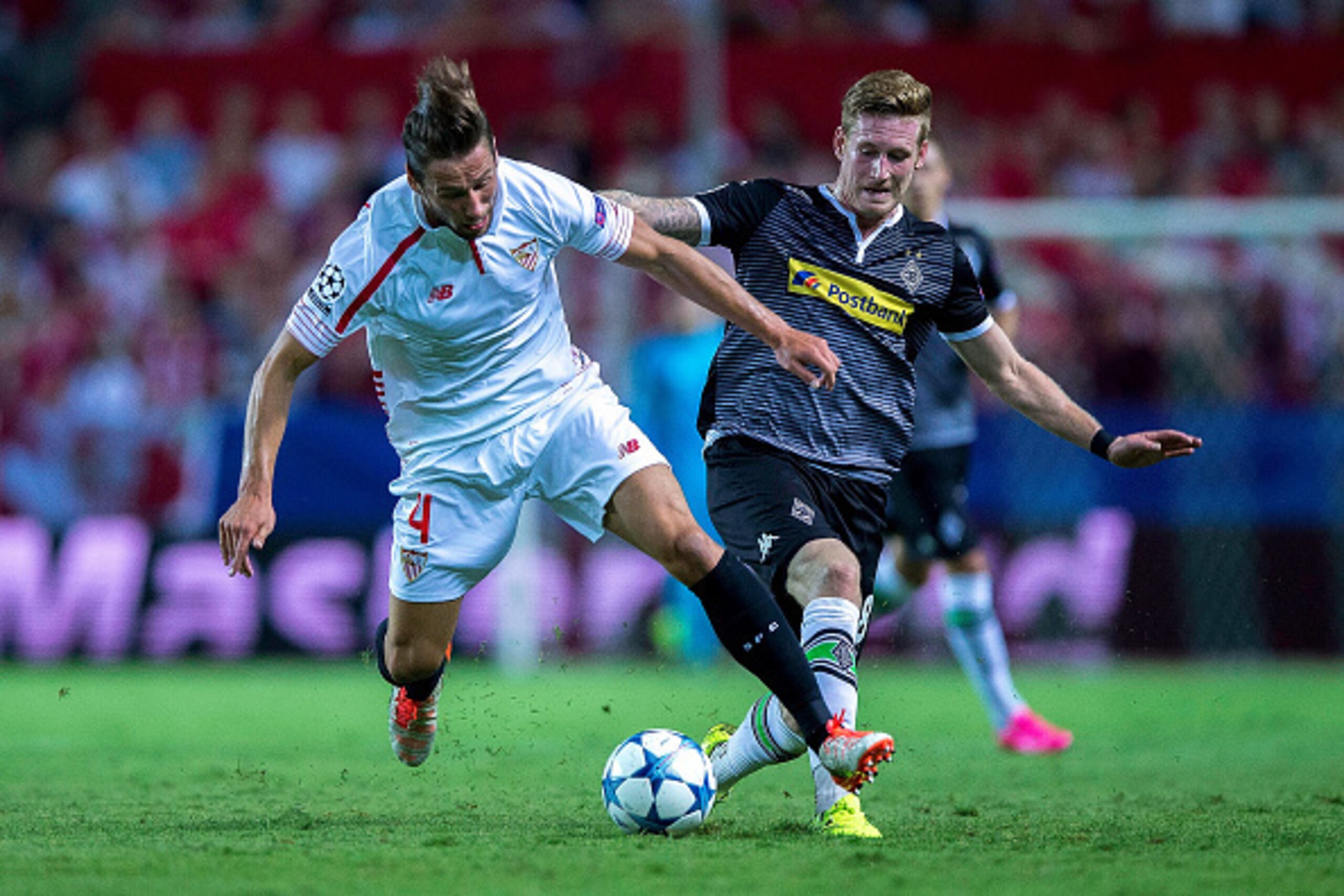 SEVILLE, SPAIN - SEPTEMBER 15:  Grzegorz Krychowiak of Sevilla FC competes for the ball with Andre Hahn (R) of Borussia Monchengladbach during the UEFA Champions League Group D match between Sevilla FC and VfL Borussia Monchengladbach at Estadio Ramon San