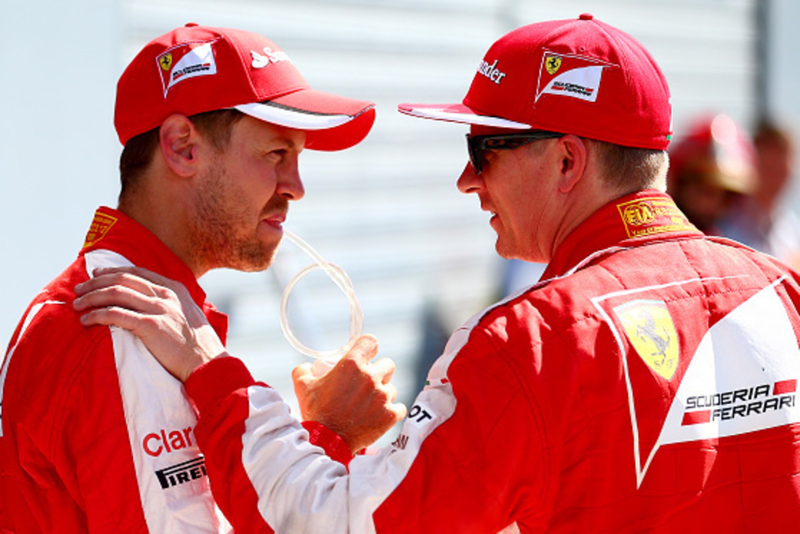 MONZA, ITALY - SEPTEMBER 05:  Kimi Raikkonen of Finland and Ferrari and Sebastian Vettel of Germany and Ferrari talk in Parc Ferme after claiming second and third respsctively on the grid during qualifying for the Formula One Grand Prix of Italy at Autodr