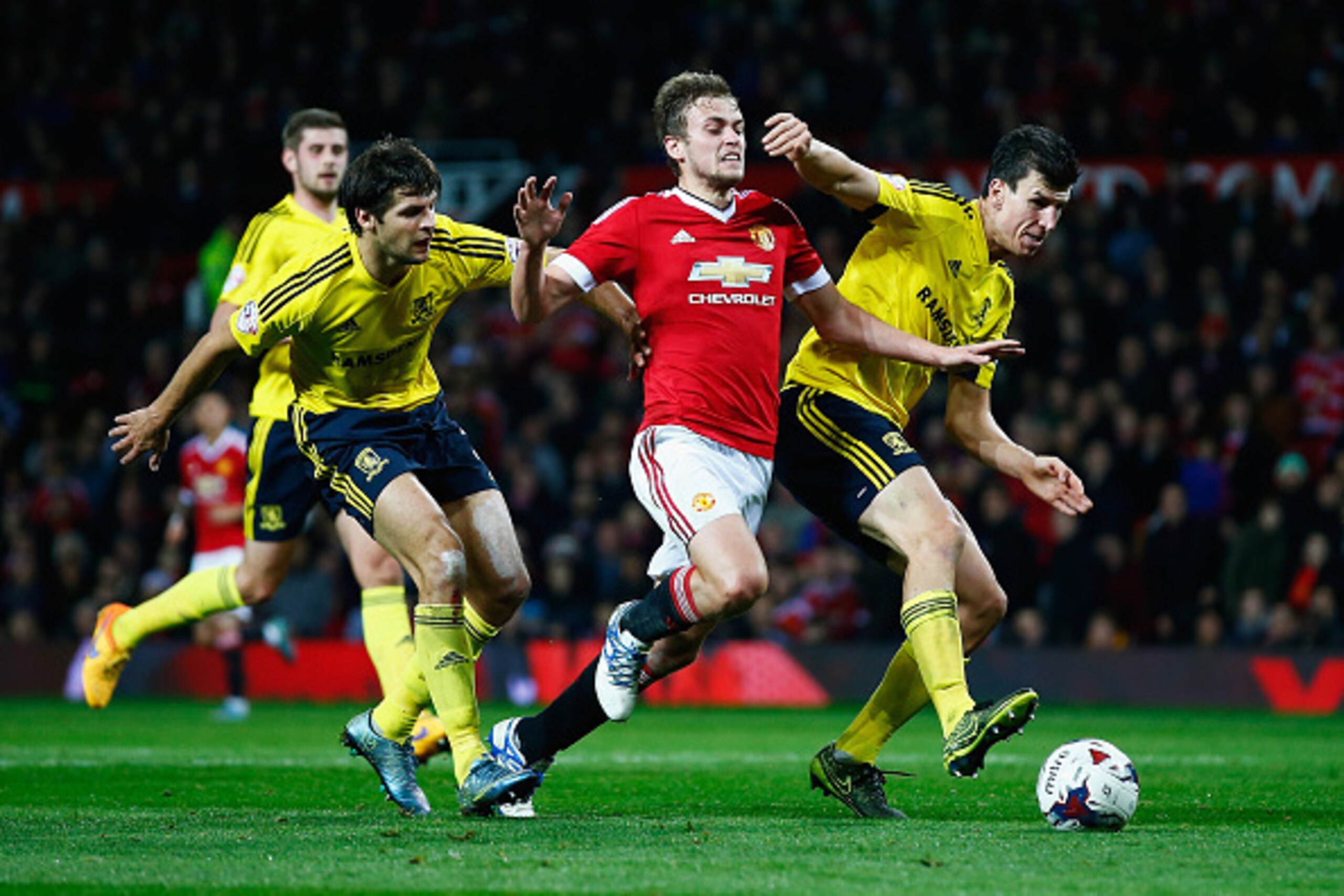 MANCHESTER, ENGLAND - OCTOBER 28:  James Wilson of Manchester United takes on George Friend (L) and Daniel Ayala of Middlesbrough during the Capital One Cup Fourth Round match between Manchester United and Middlesbrough at Old Trafford on October 28, 2015