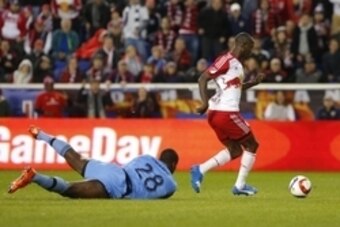 Nov 8, 2015; Harrison, NJ, USA; New York Red Bulls forward Bradley Wright-Phillips (99) dribbles by D.C. United goalkeeper Bill Hamid (28) to score a goal during second half of MLS Playoffs game at Red Bull Arena. The New York Red Bulls defeated  D.C. Uni