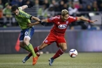 Nov 1, 2015; Seattle, WA, USA; Seattle Sounders FC defender Zach Scott (20) takes down FC Dallas forward David Texeira (9) during the second half at CenturyLink Field. Mandatory Credit: Jennifer Buchanan-USA TODAY Sports