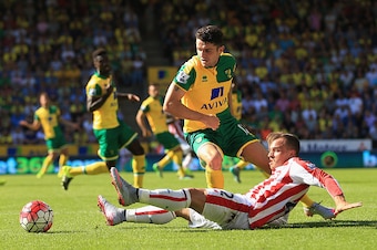 NORWICH, ENGLAND - AUGUST 22: Robbie Brady of Norwich City and Xherdan Shaqiri of Stoke City compete for the ball during the Barclays Premier League match between Norwich City and Stoke City at Carrow Road on August 22, 2015 in Norwich, England.  (Photo b