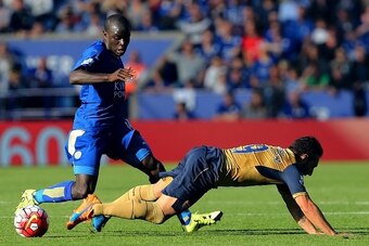 Arsenals Spanish midfielder Santi Cazorla (R) falls next to Leicester Citys French midfielder NGolo Kante (L)  during the English Premier League football match between Leicester City and Arsenal at King Power Stadium in Leicester, central England on Septe