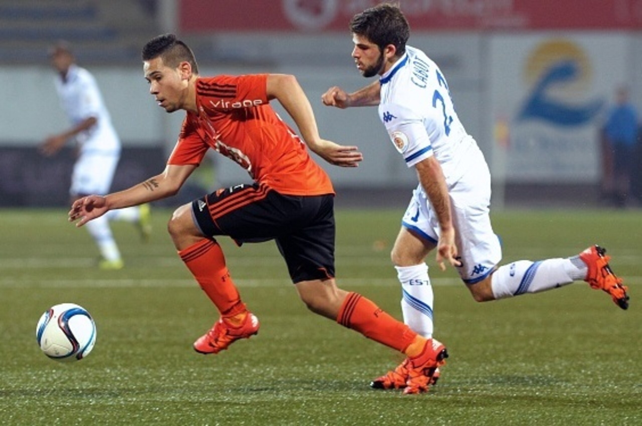 Lorient's French Portuguese defender Raphael Guerreiro (L) vies with Troyes's French forward Jimmy Cabot during the French L1 football match between Lorient and Troyes on November 7, 2015 at the Yves Allainmat stadium in Lorient, western France. AFP PHOTO