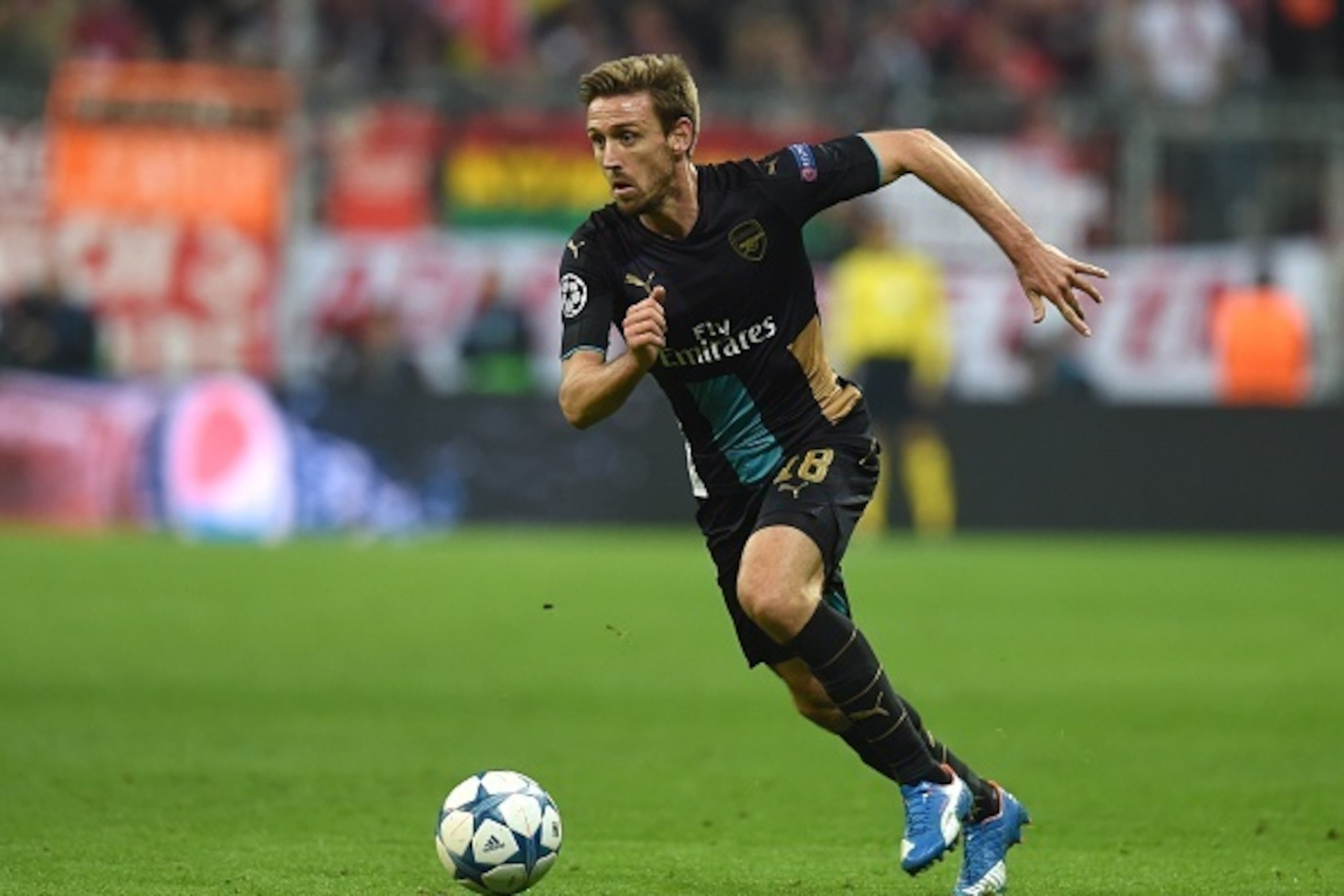 Arsenal's Spanish defender Nacho Monreal runs with the ball during the UEFA Champions League Group F second-leg football match between FC Bayern Munich and Arsenal FC in Munich, southern Germany, on November 4, 2015. Bayern won the match 5-1. AFP PHOTO / Arsenal's Spanish defender Nacho Monreal runs with the ball during the UEFA Champions League Group F second-leg football match between FC Bayern Munich and Arsenal FC in Munich, southern Germany, on November 4, 2015. Bayern won the match 5-1. AFP PHOTO /