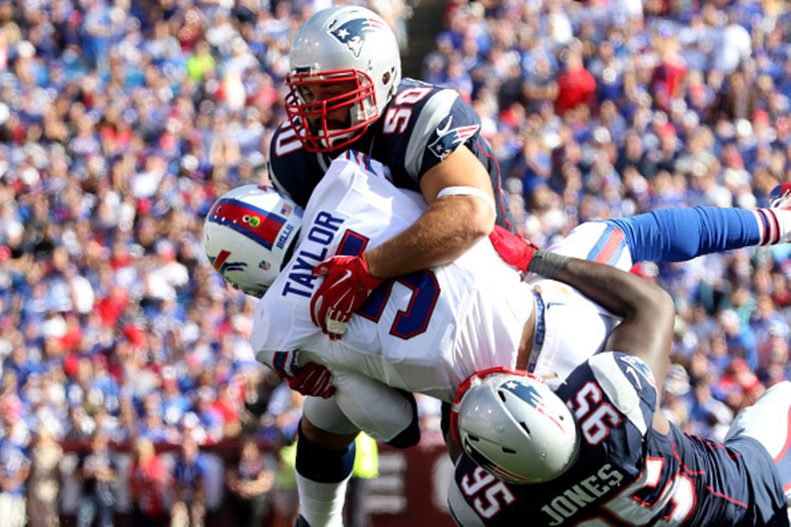 ORCHARD PARK, NY - SEPTEMBER 20:  Chandler Jones #95  and Rob Ninkovich of the New England Patriots  combine to sack Tyrod Taylor #5 of the Buffalo Bills during the first half against the Buffalo Bills  at Ralph Wilson Stadium on September 20, 2015 in Orc