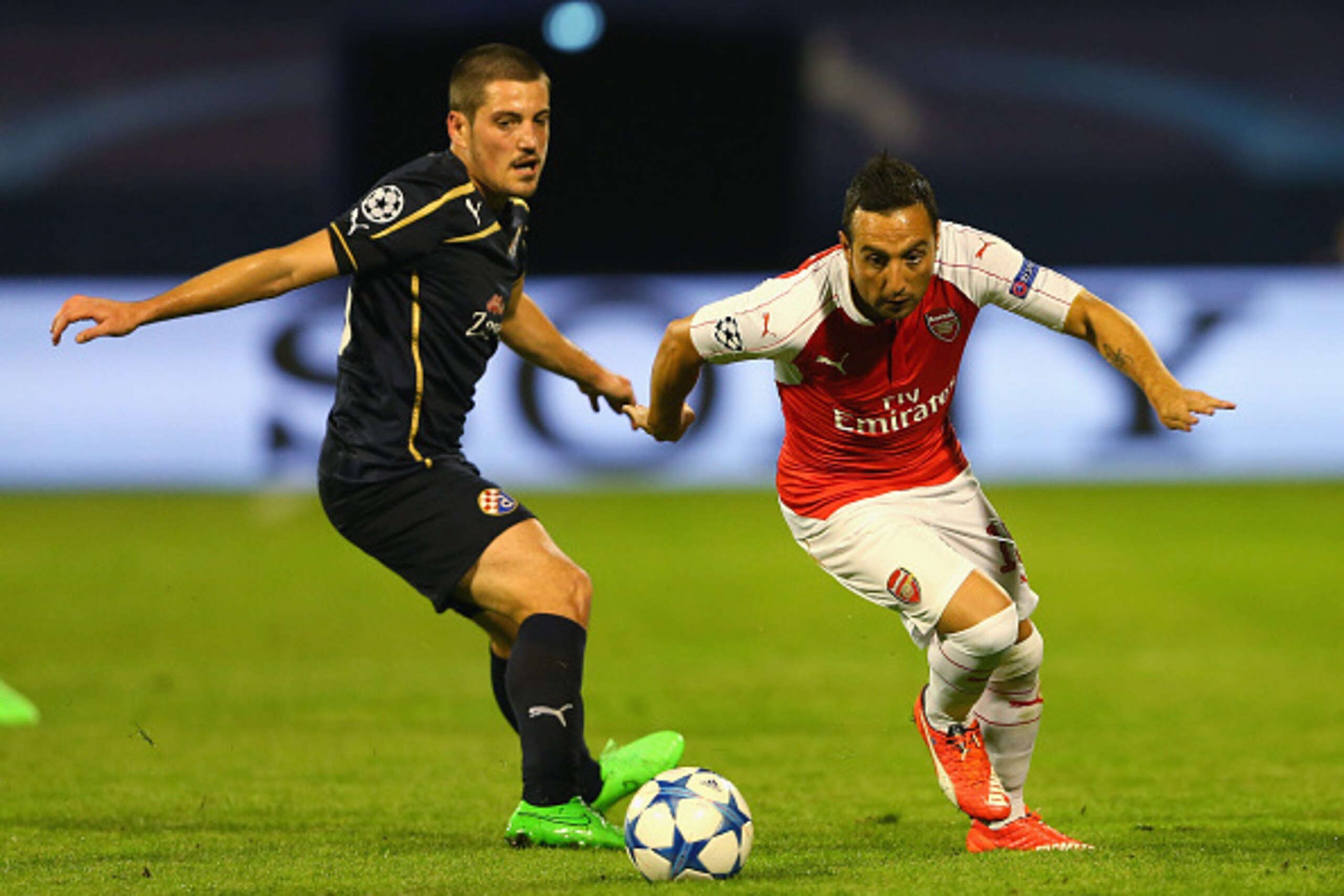 ZAGREB, CROATIA - SEPTEMBER 16:  Santi Cazorla of Arsenal goes past Arijan Ademi of Dinamo Zagreb during the UEFA Champions League Group F match between Dinamo Zagreb and Arsenal at Maksimir Stadium on September 16, 2015 in Zagreb, Croatia.  (Photo by Ale
