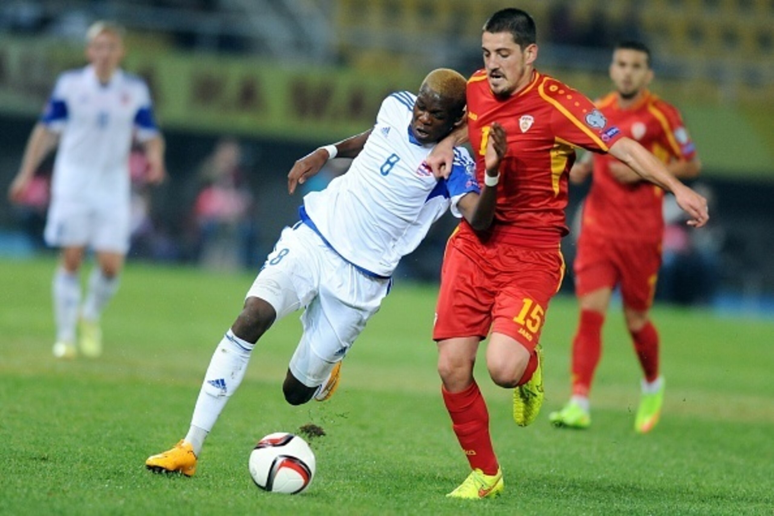 Macedonia's midfielder Arijan Ademi (R) vies with Luxembourg 's defender Christopher Martins Pereira (L) during the Euro 2016 group D qualifying football match between Macedonia and Luxembourg at Filip II stadium in Skopje on October 9, 2014. AFP PHOTO / 