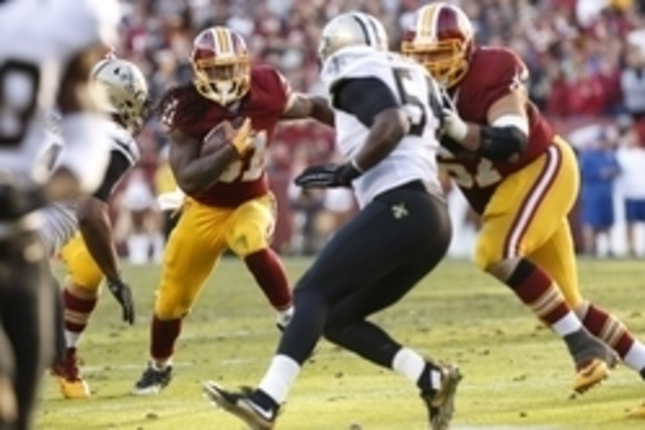 Nov 15, 2015; Landover, MD, USA; Washington Redskins running back Matt Jones (31) carries the ball as New Orleans Saints defensive end Cameron Jordan (94) and Saints linebacker Jo-Lonn Dunbar (54) chase in the fourth quarter at FedEx Field. The Redskins w