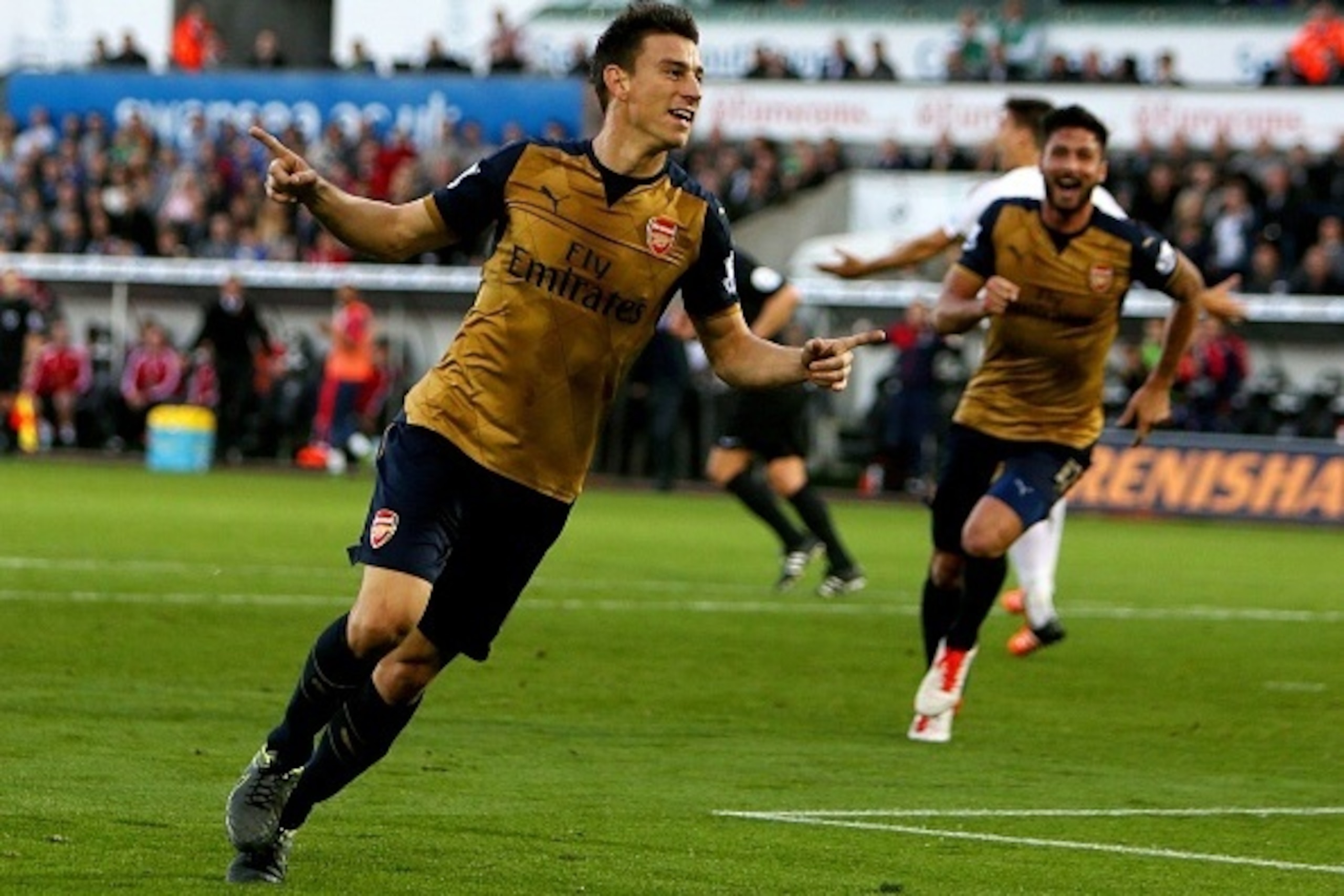 Arsenal's French defender Laurent Koscielny celebrates after scoring their second goal during the English Premier League football match between Swansea City and Arsenal at The Liberty Stadium in Swansea, south Wales on October 31, 2015. AFP PHOTO / GEOFF 