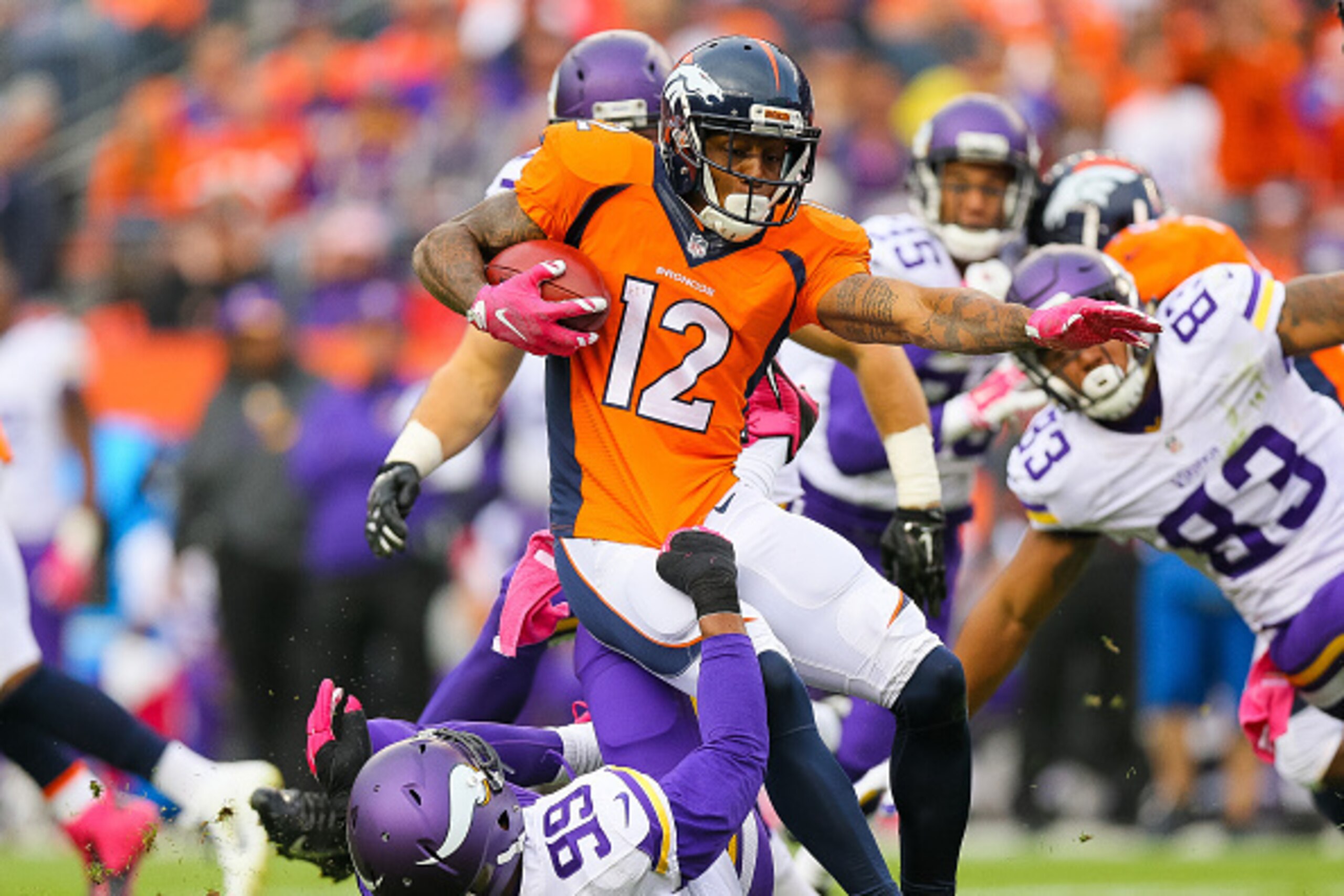 DENVER, CO - OCTOBER 4:  Wide receiver Andre Caldwell #12 of the Denver Broncos is tackled by defensive end Danielle Hunter #99 of the Minnesota Vikings after a catch at Sports Authority Field at Mile High on October 4, 2015 in Denver, Colorado.  (Photo b