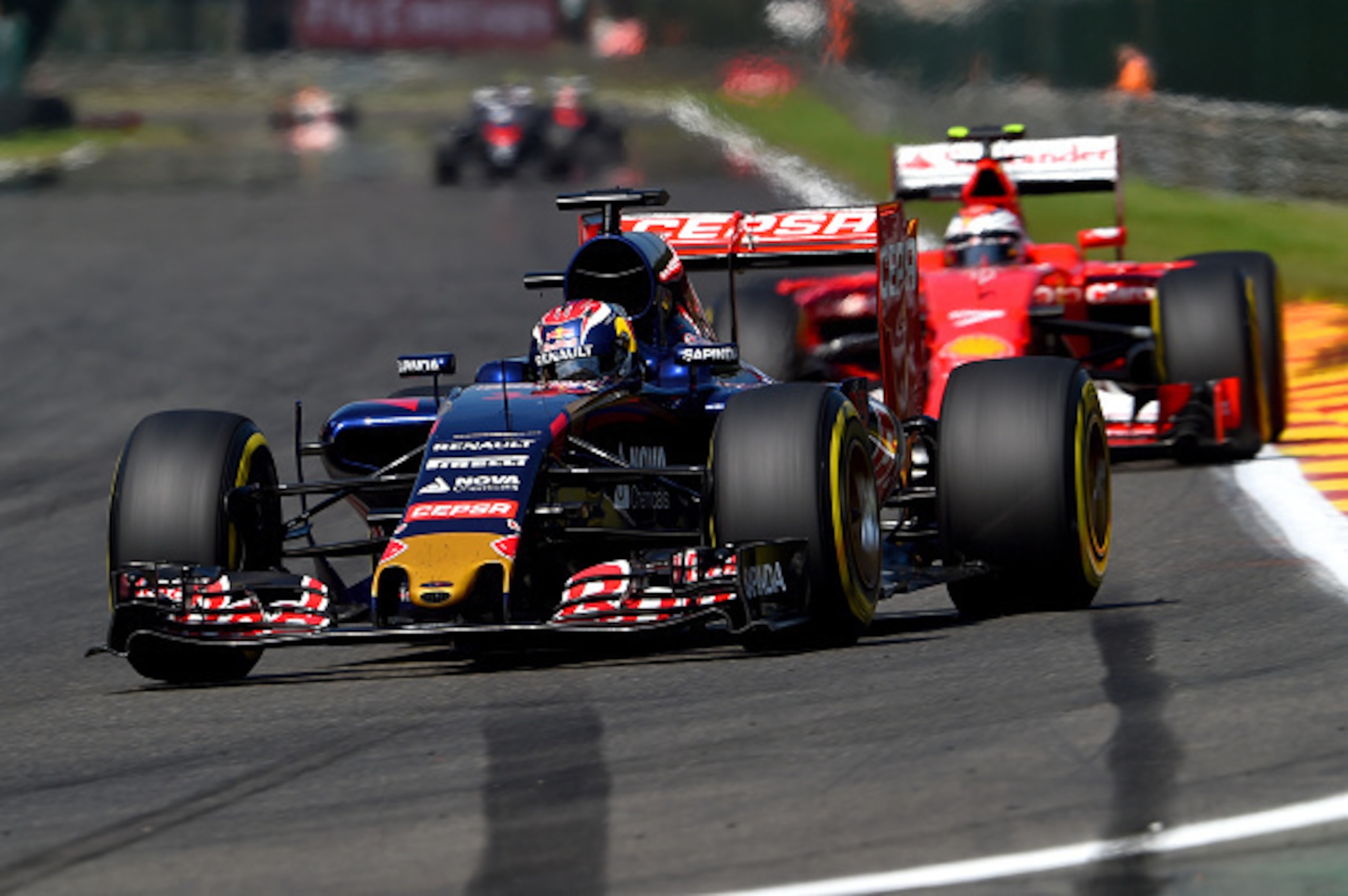 SPA, BELGIUM - AUGUST 23:  Max Verstappen of Netherlands and Scuderia Toro Rosso drives ahead of Kimi Raikkonen of Finland and Ferrari during the Formula One Grand Prix of Belgium at Circuit de Spa-Francorchamps on August 23, 2015 in Spa, Belgium.  (Photo