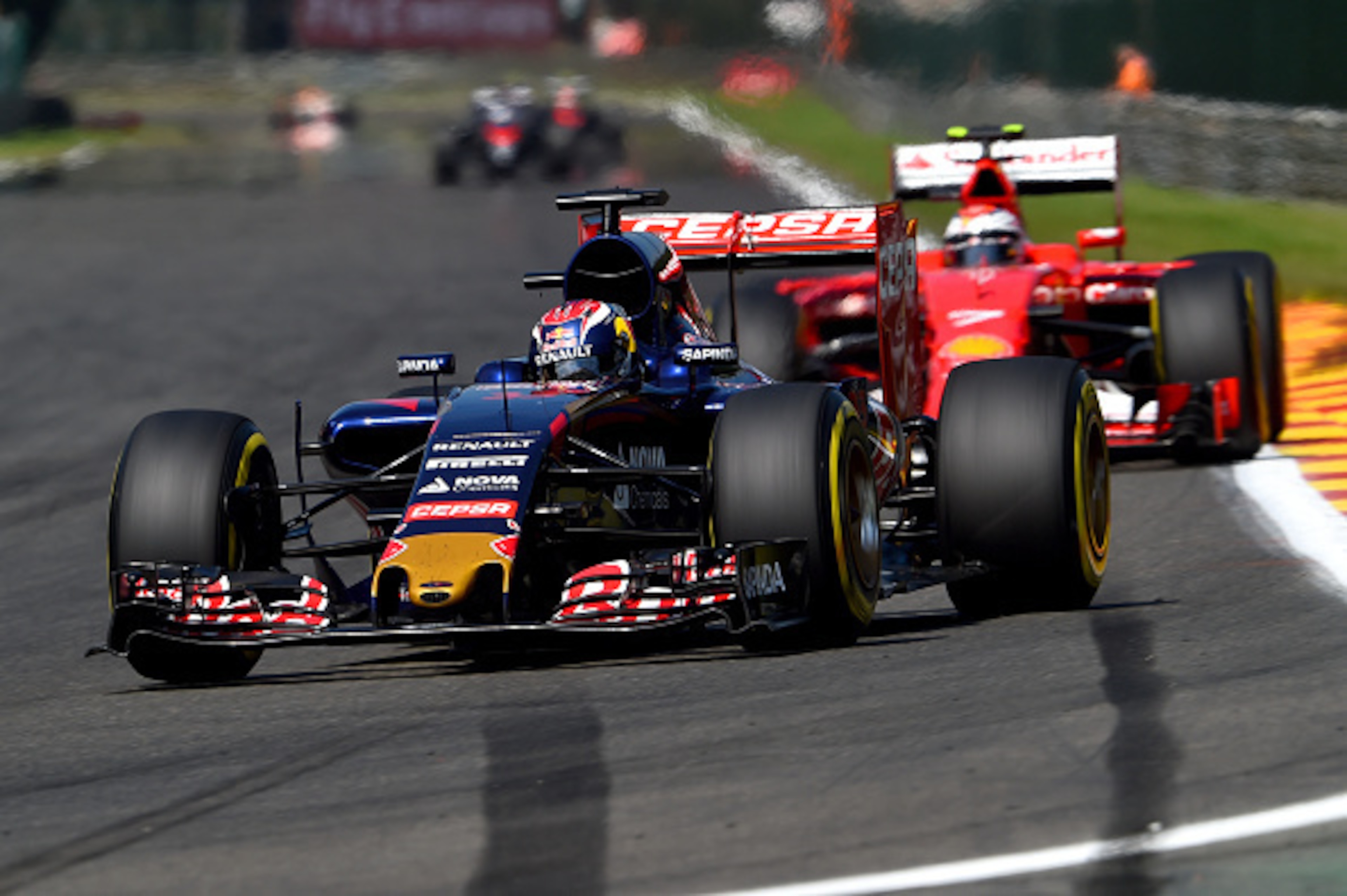 SPA, BELGIUM - AUGUST 23: Max Verstappen of Netherlands and Scuderia Toro Rosso drives ahead of Kimi Raikkonen of Finland and Ferrari during the Formula One Grand Prix of Belgium at Circuit de Spa-Francorchamps on August 23, 2015 in Spa, Belgium. (Photo SPA, BELGIUM - AUGUST 23: Max Verstappen of Netherlands and Scuderia Toro Rosso drives ahead of Kimi Raikkonen of Finland and Ferrari during the Formula One Grand Prix of Belgium at Circuit de Spa-Francorchamps on August 23, 2015 in Spa, Belgium. (Photo