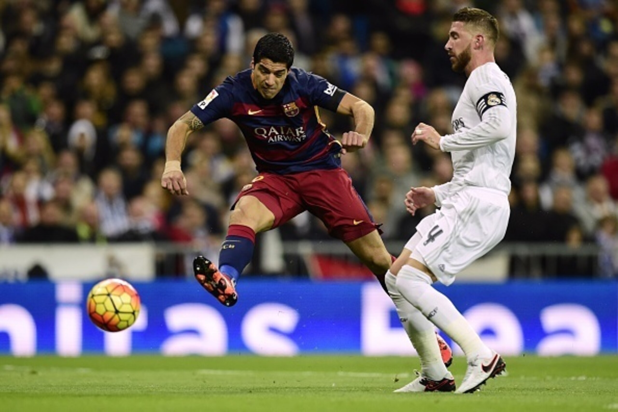 Barcelona's Uruguayan forward Luis Suarez (L) scores past Real Madrid's defender Sergio Ramos during the Spanish league 'Clasico' football match Real Madrid CF vs FC Barcelona at the Santiago Bernabeu stadium in Madrid on November 21, 2015. AFP PHOTO/ JAV Barcelona's Uruguayan forward Luis Suarez (L) scores past Real Madrid's defender Sergio Ramos during the Spanish league 'Clasico' football match Real Madrid CF vs FC Barcelona at the Santiago Bernabeu stadium in Madrid on November 21, 2015. AFP PHOTO/ JAV