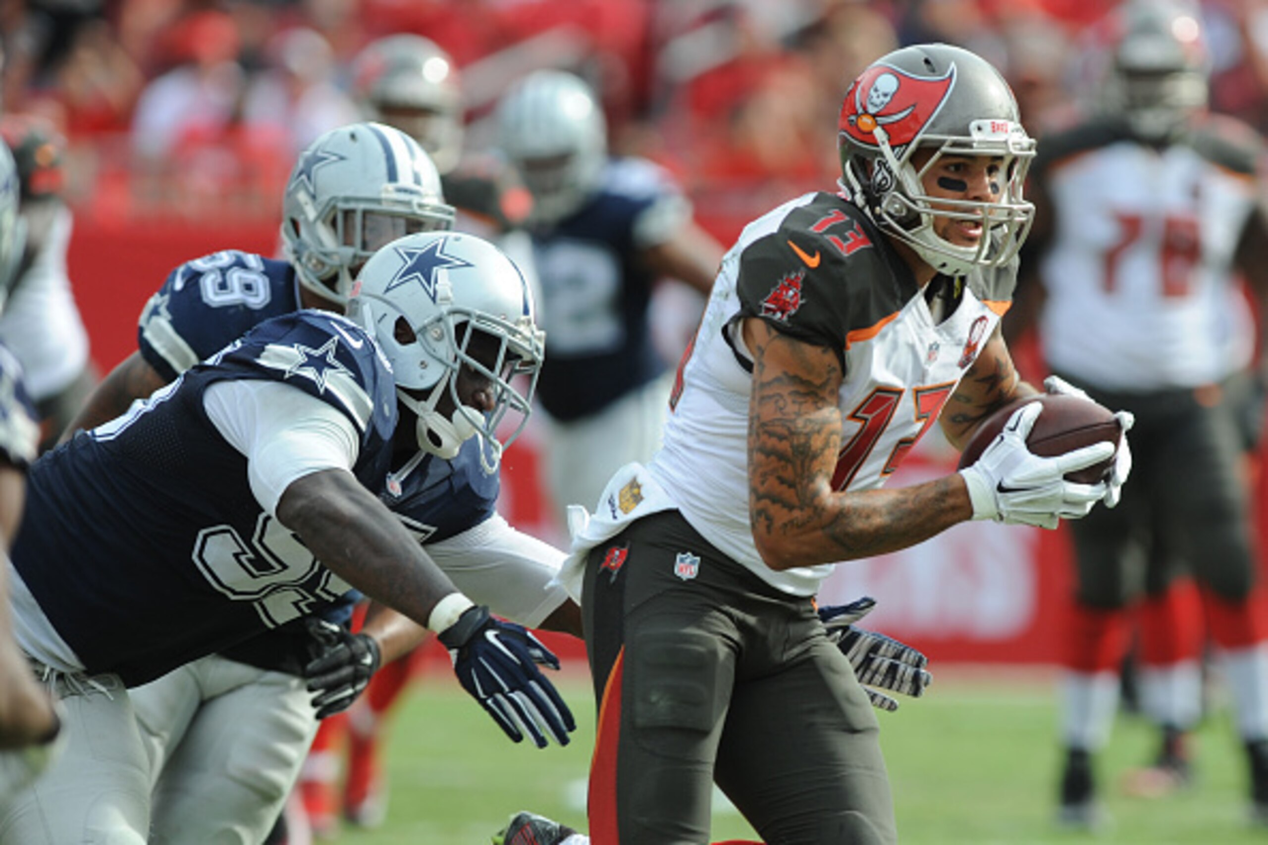 TAMPA, FL - NOVEMBER 15: Wide receiver Mike Evans #13 of the Tampa Bay Buccaneers runs after the catch past defensive tackle David Irving #95 of the Dallas Cowboys in the second quarter at Raymond James Stadium on November 15, 2015 in Tampa, Florida. (Pho