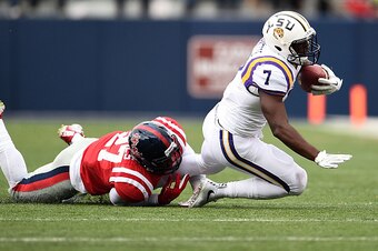 OXFORD, MS - NOVEMBER 21:  Leonard Fournette #7 of the LSU Tigers is brought down by Marquis Haynes #27 of the Mississippi Rebels during the first quarter of a game at Vaught-Hemingway Stadium on November 21, 2015 in Oxford, Mississippi.  (Photo by Stacy 