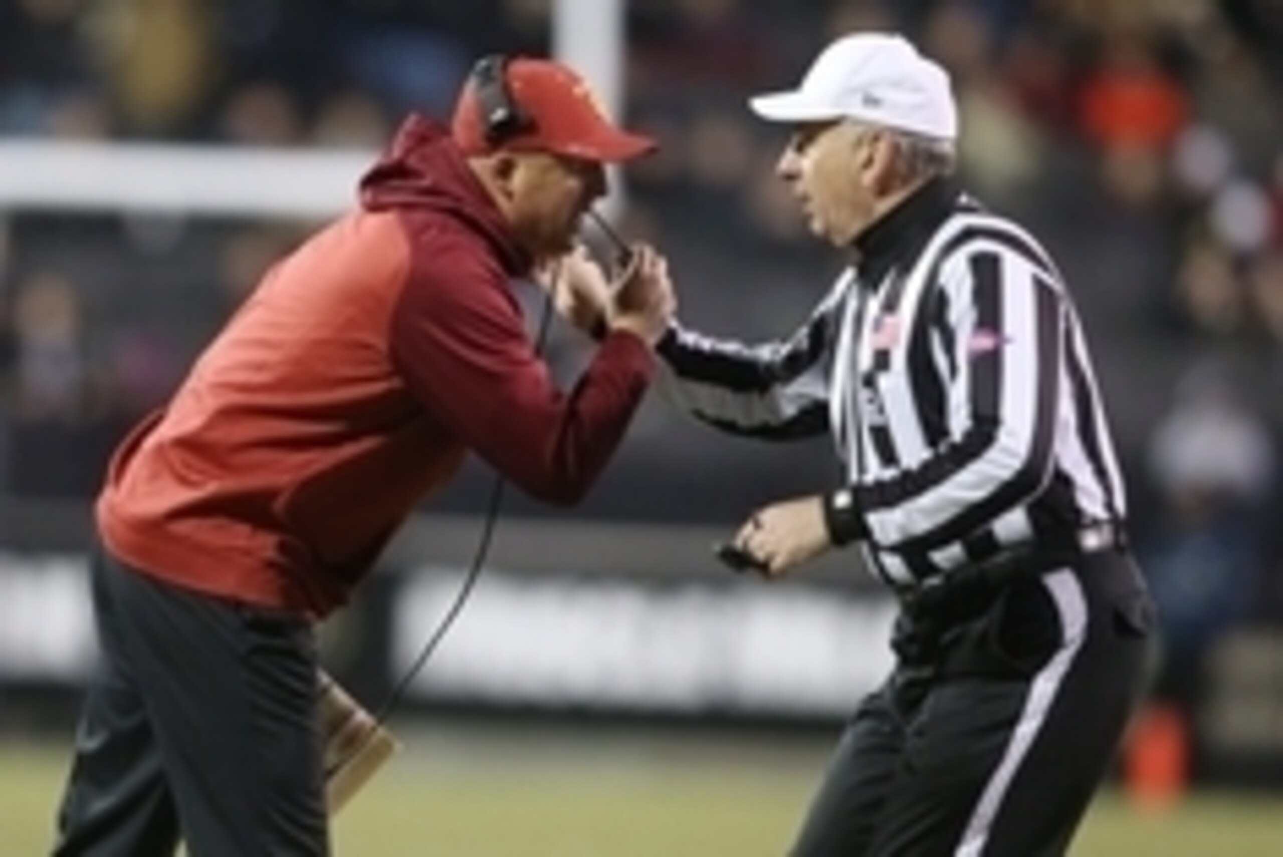 Nov 13, 2015; Boulder, CO, USA; USC Trojans head coach Clay Helton (right) confers with referee Michael Batlan (left) during the second half against the Colorado Buffaloes at Folsom Field. The Trojans won 27-24. Mandatory Credit: Chris Humphreys-USA TODAY