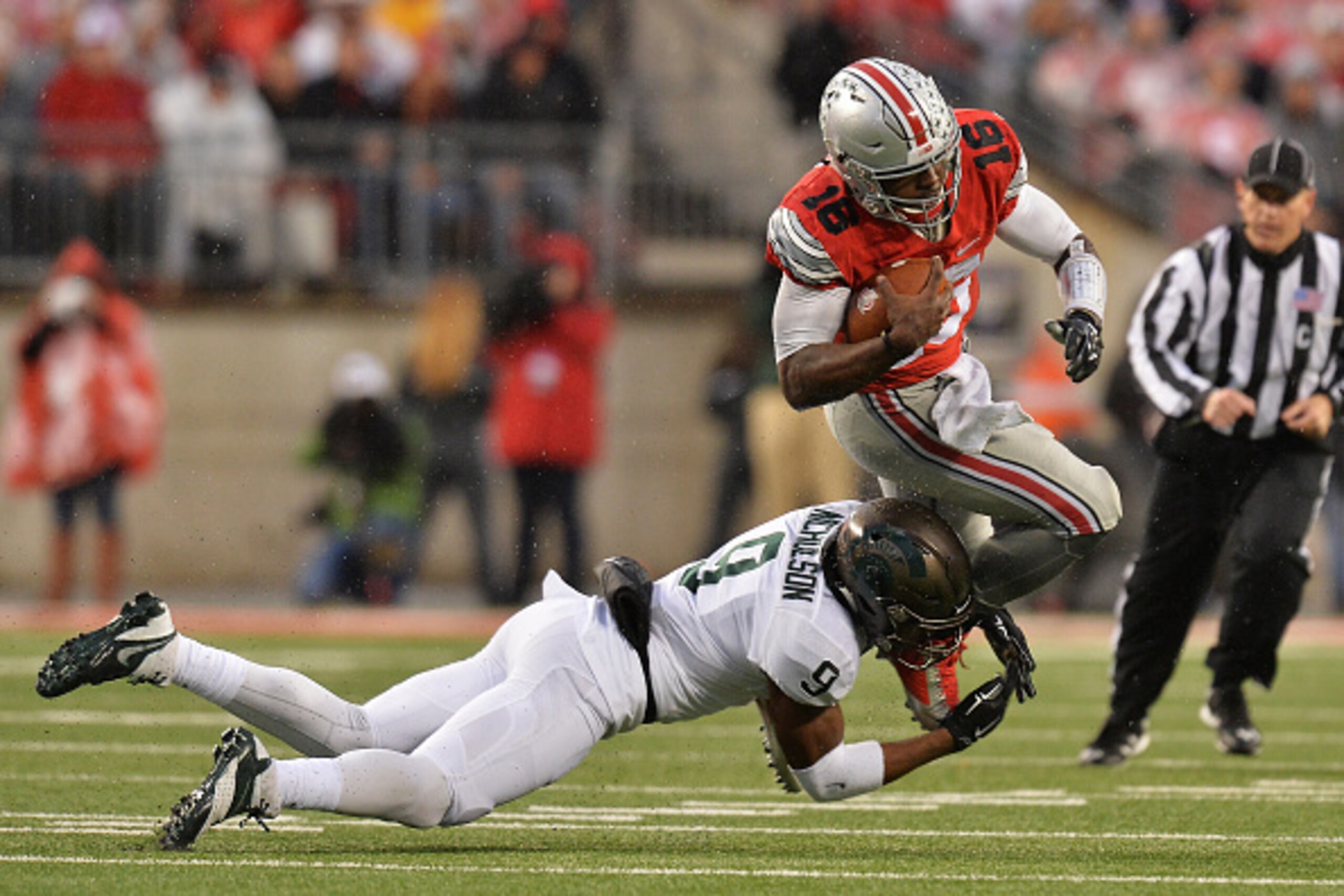 COLUMBUS, OH - NOVEMBER 21:  Montae Nicholson #9 of the Michigan State Spartans tackles J.T. Barrett #16 of the Ohio State Buckeyes for no gain in the  first quarter at Ohio Stadium on November 21, 2015 in Columbus, Ohio.  (Photo by Jamie Sabau/Getty Imag