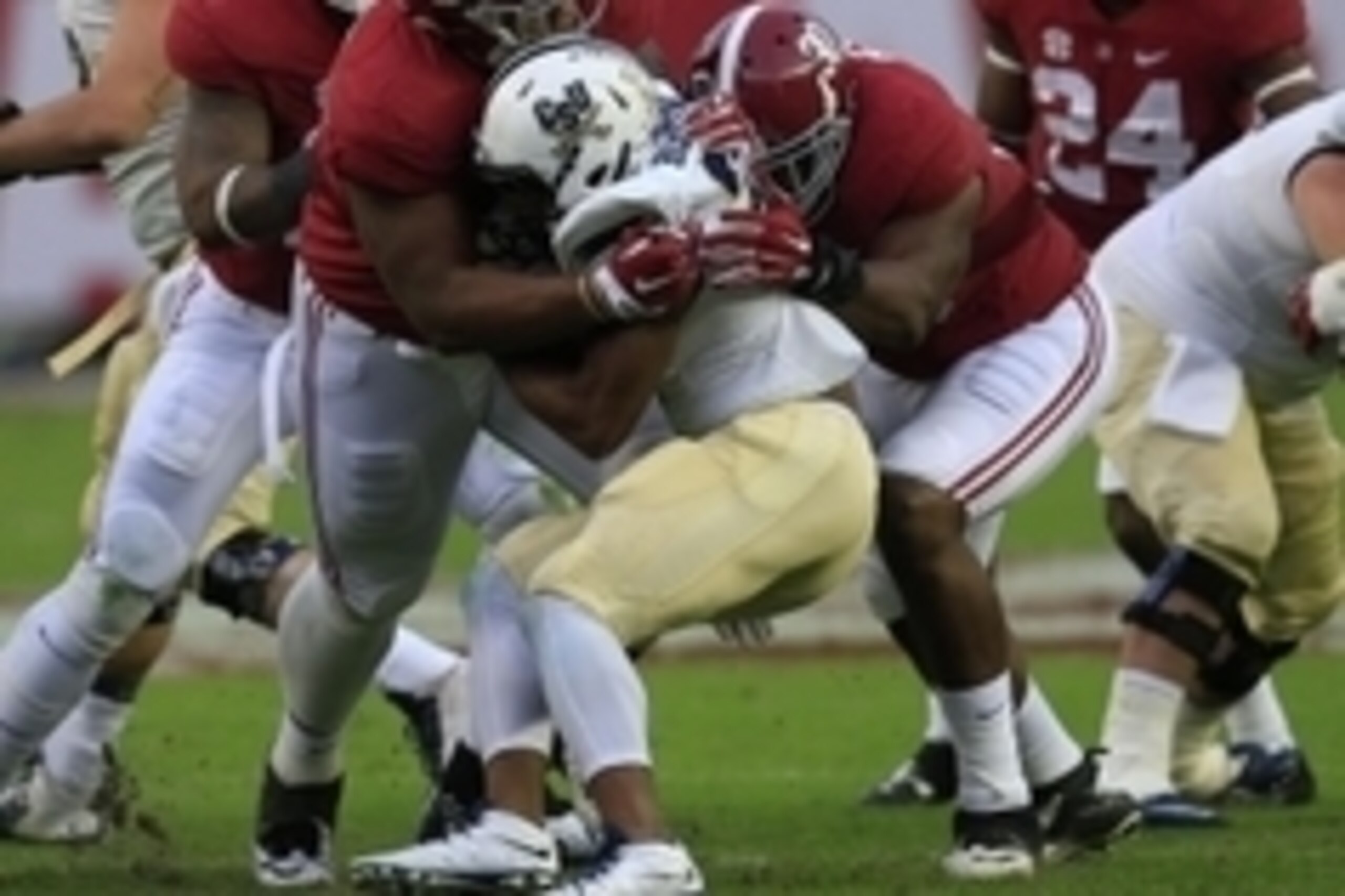 Nov 21, 2015; Tuscaloosa, AL, USA; Alabama Crimson Tide defensive lineman Daron Payne (94) and linebacker Denzel Devall (30) wrap up Charleston Southern Buccaneers running back Darius Hammond (24)  at Bryant-Denny Stadium. Mandatory Credit: Marvin Gentry-