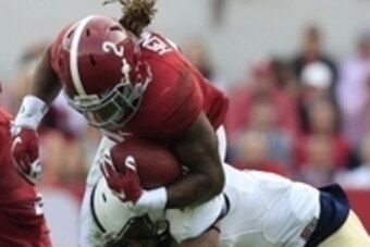 Nov 21, 2015; Tuscaloosa, AL, USA; Alabama Crimson Tide running back Derrick Henry (2) is hit by a Charleston Southern Buccaneers defender at Bryant-Denny Stadium. Mandatory Credit: Marvin Gentry-USA TODAY Sports