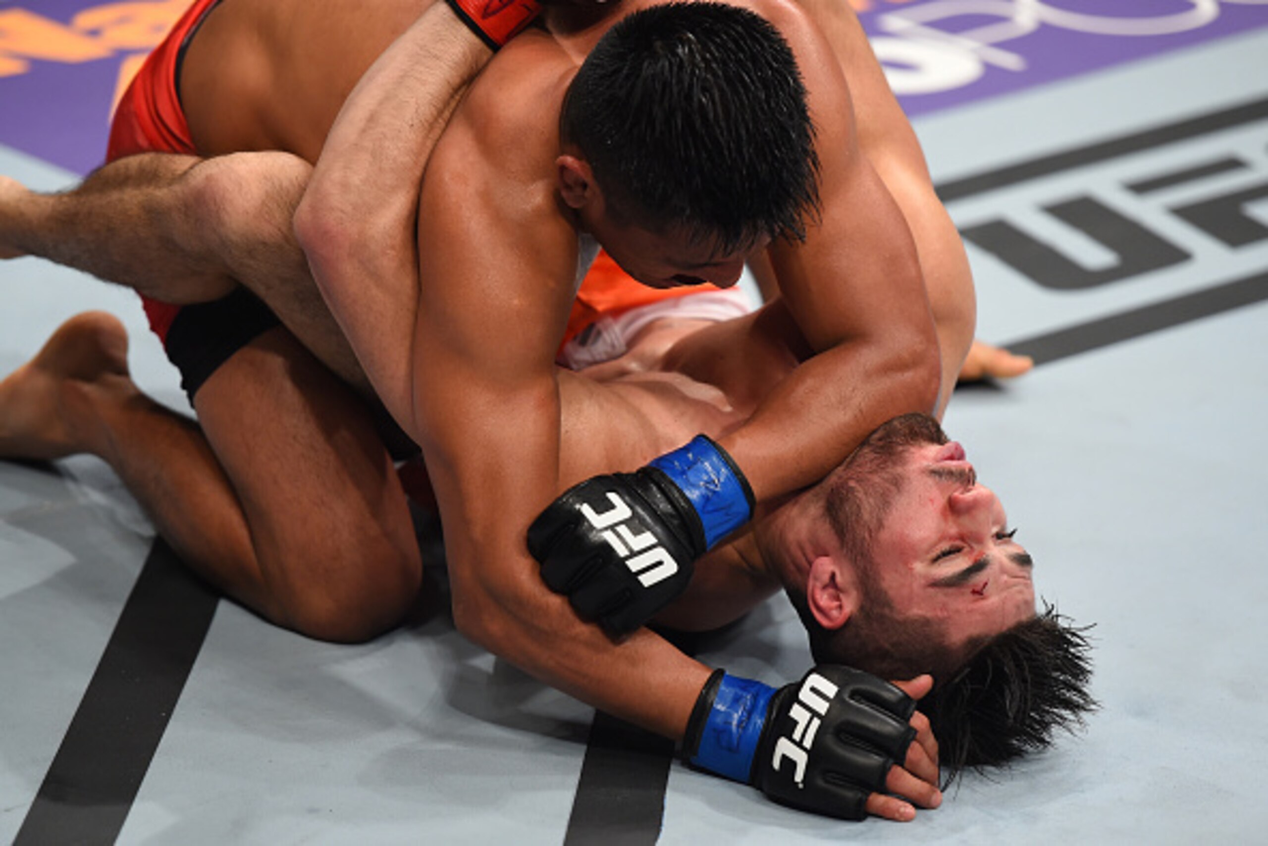 MONTERREY, MEXICO - NOVEMBER 21:  (L-R) Enrique Barzola of Peru elbows Horacio Gutierrez of Mexico in their lightweight bout during the UFC Fight Night event at Arena Monterrey on November 21, 2015 in Monterrey, Mexico.  (Photo by Jeff Bottari/Zuffa LLC/Z