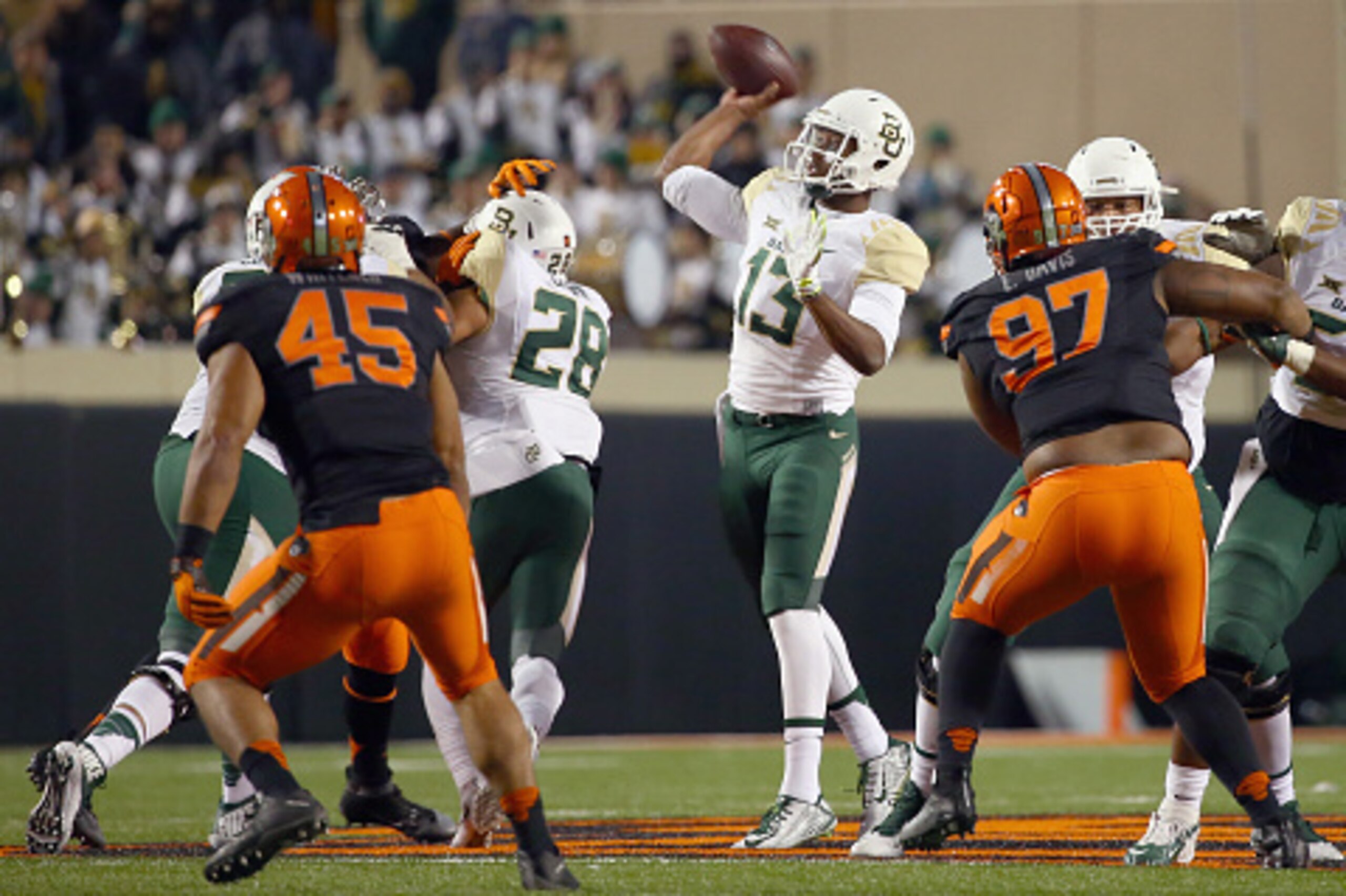 STILLWATER, OK - NOVEMBER 21: Chris Johnson #13 of the Baylor Bears looks for an open receiver in the second half against the Oklahoma State Cowboys at Boone Pickens Stadium on November 21, 2015 in Stillwater, Oklahoma. (Photo by Tom Pennington/Getty Im STILLWATER, OK - NOVEMBER 21: Chris Johnson #13 of the Baylor Bears looks for an open receiver in the second half against the Oklahoma State Cowboys at Boone Pickens Stadium on November 21, 2015 in Stillwater, Oklahoma. (Photo by Tom Pennington/Getty Im