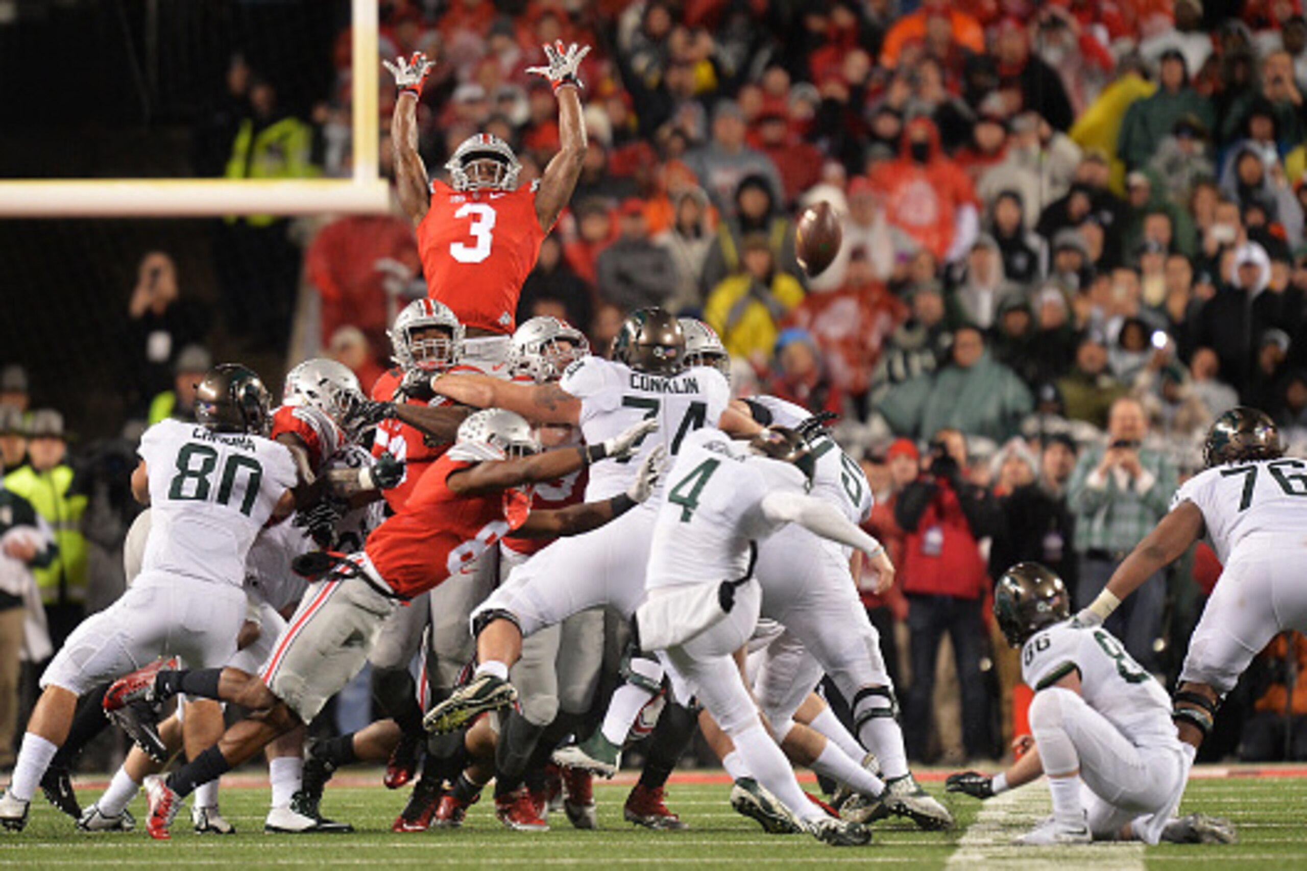 COLUMBUS, OH - NOVEMBER 21:  Michael Thomas #3 of the Ohio State Buckeyes goes high to attempt to block a 41-yard field goal attempt by Michael Geiger #4 of the Michigan State Spartans as time expires at Ohio Stadium on November 21, 2015 in Columbus, Ohio