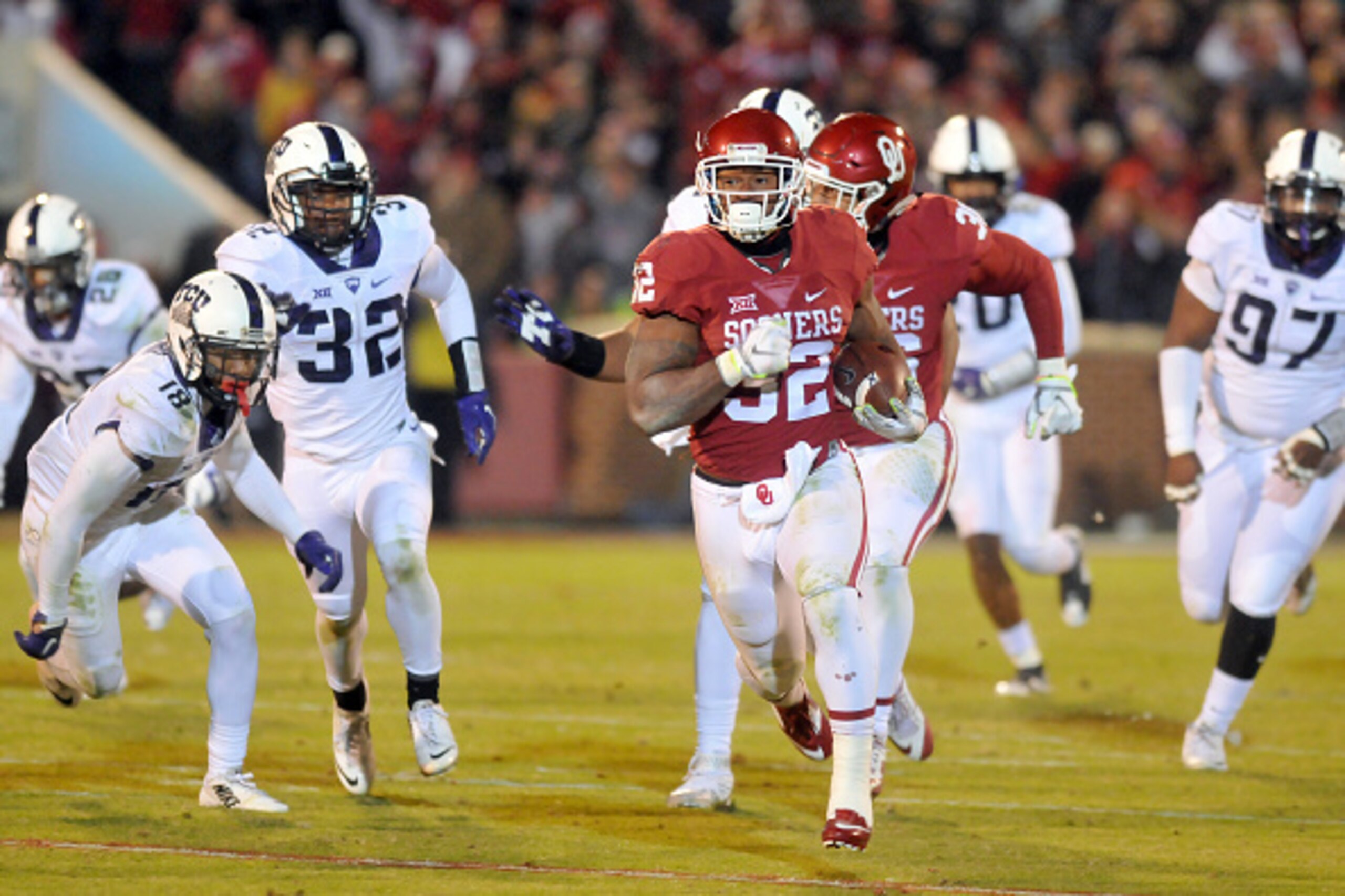 NORMAN, OK - NOVEMBER 21: Running back Samaje Perine #32 of the Oklahoma Sooners runs for a second half touchdown past cornerback Nick Orr #18 and linebacker Travin Howard #32 of the TCU Horned Frogs on November 21, 2015 at the Gaylord Family Oklahoma Mem