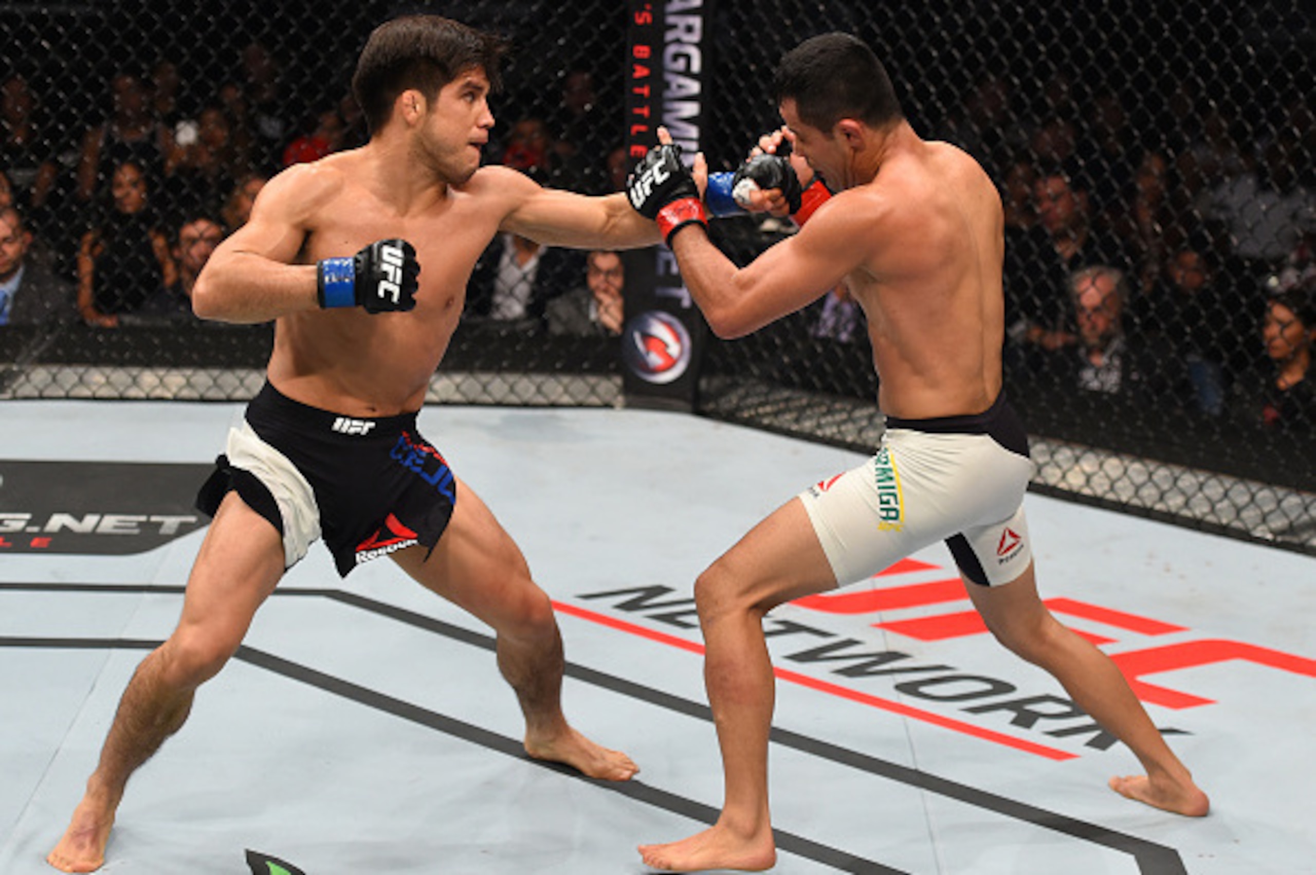 MONTERREY, MEXICO - NOVEMBER 21:  (L-R) Henry Cejudo of the United States punches Jussier Formiga of Brazil in their flyweight bout during the UFC Fight Night event at Arena Monterrey on November 21, 2015 in Monterrey, Mexico.  (Photo by Jeff Bottari/Zuff